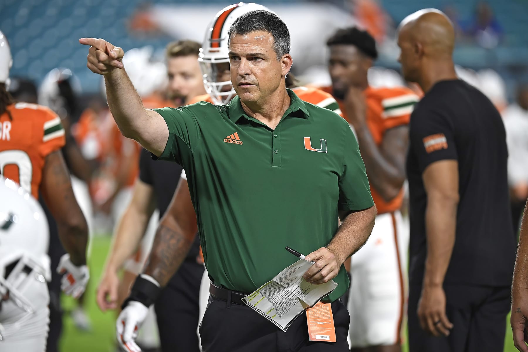 MIAMI GARDENS, FL - NOVEMBER 26:  Miami head coach Mario Cristobal directs players during drills prior to the game as the Miami Hurricanes faced the Pitt Panthers on November 26, 2022, at Hard Rock Stadium in Miami Gardens, Florida. (Photo by Samuel Lewis/Icon Sportswire via Getty Images)