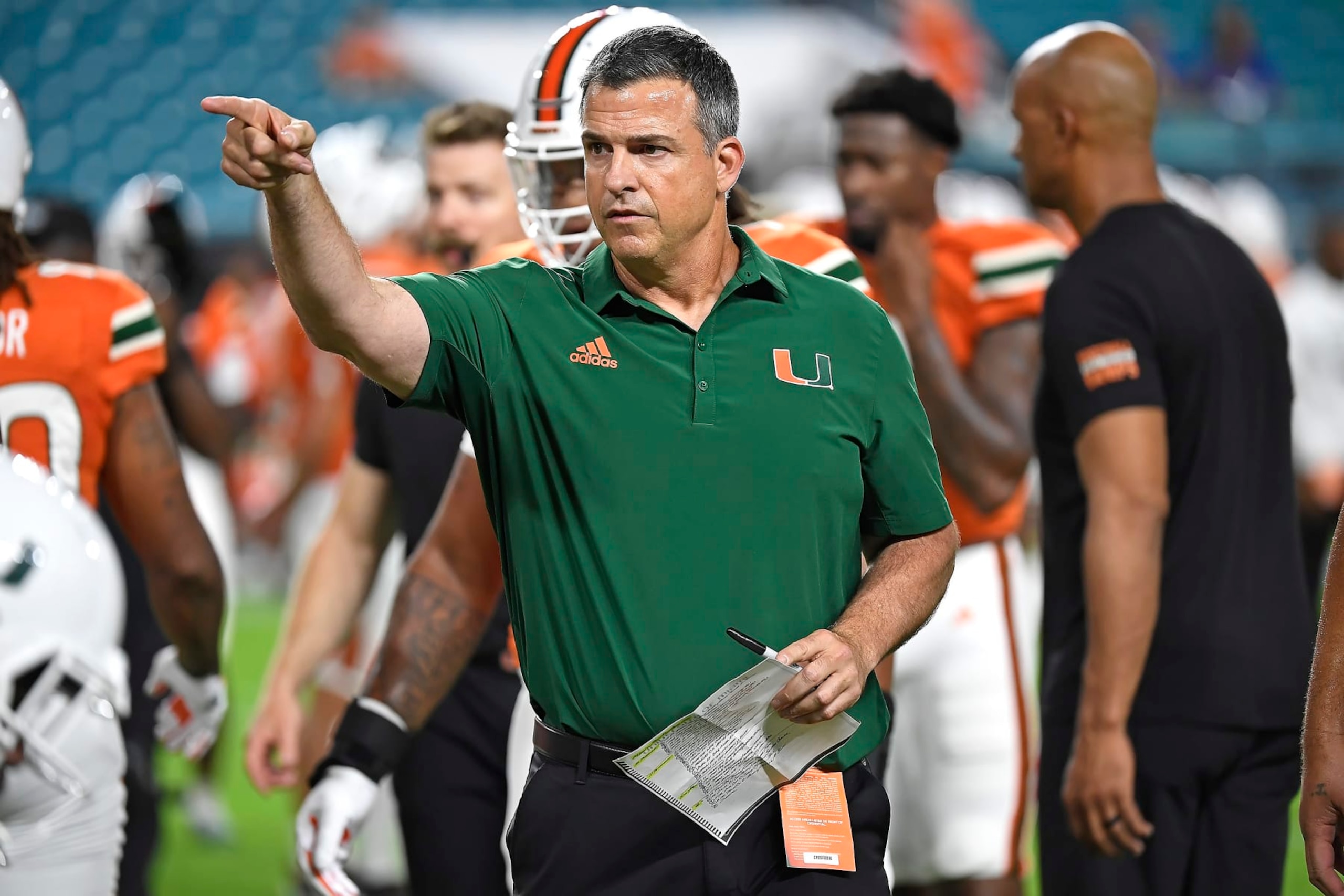 MIAMI GARDENS, FL - NOVEMBER 26:  Miami head coach Mario Cristobal directs players during drills prior to the game as the Miami Hurricanes faced the Pitt Panthers on November 26, 2022, at Hard Rock Stadium in Miami Gardens, Florida. (Photo by Samuel Lewis/Icon Sportswire via Getty Images)