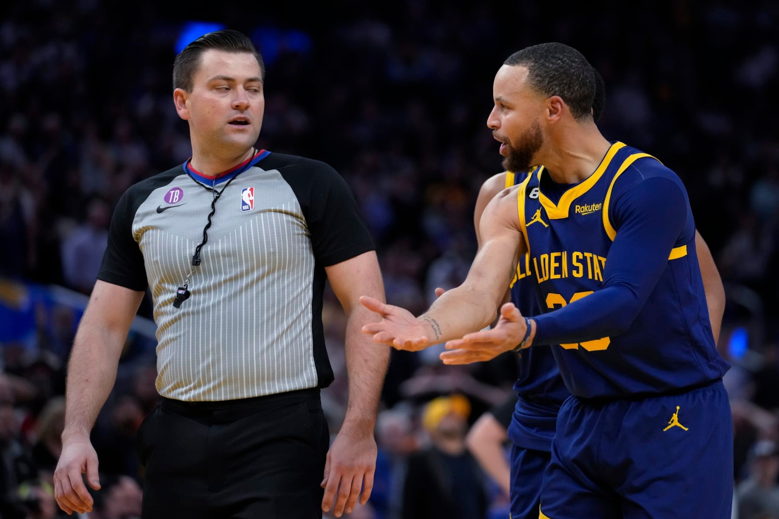 Golden State Warriors guard Stephen Curry, right, reacts after being charged with a technical foul during the second half of the team's NBA basketball game against the Memphis Grizzlies in San Francisco, Wednesday, Jan. 25, 2023. Curry was ejected. (AP Photo/Godofredo A. Vásquez)