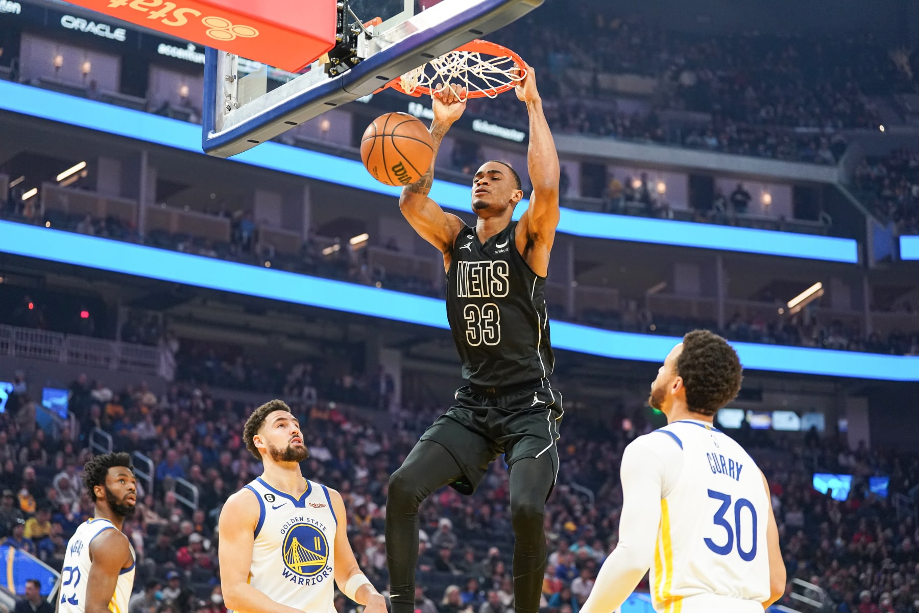 SAN FRANCISCO, CA - JANUARY 22: Nic Claxton #33 of the Brooklyn Nets dunks the ball in the first quarter against Stephen Curry #30 of the Golden State Warriors at Chase Center on January 22, 2023 in San Francisco, California. NOTE TO USER: User expressly acknowledges and agrees that, by downloading and/or using this photograph, User is consenting to the terms and conditions of the Getty Images License Agreement. (Photo by Kavin Mistry/Getty Images)