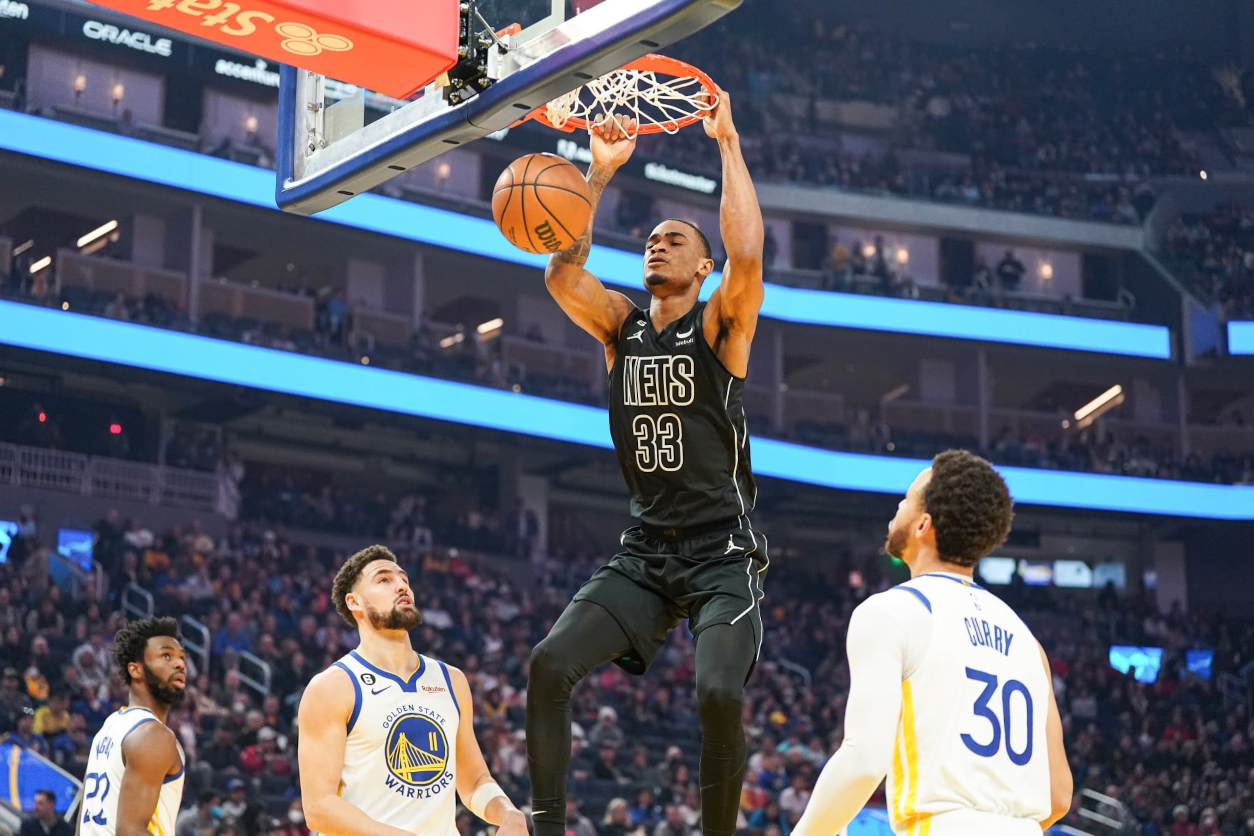 SAN FRANCISCO, CA - JANUARY 22: Nic Claxton #33 of the Brooklyn Nets dunks the ball in the first quarter against Stephen Curry #30 of the Golden State Warriors at Chase Center on January 22, 2023 in San Francisco, California. NOTE TO USER: User expressly acknowledges and agrees that, by downloading and/or using this photograph, User is consenting to the terms and conditions of the Getty Images License Agreement. (Photo by Kavin Mistry/Getty Images)