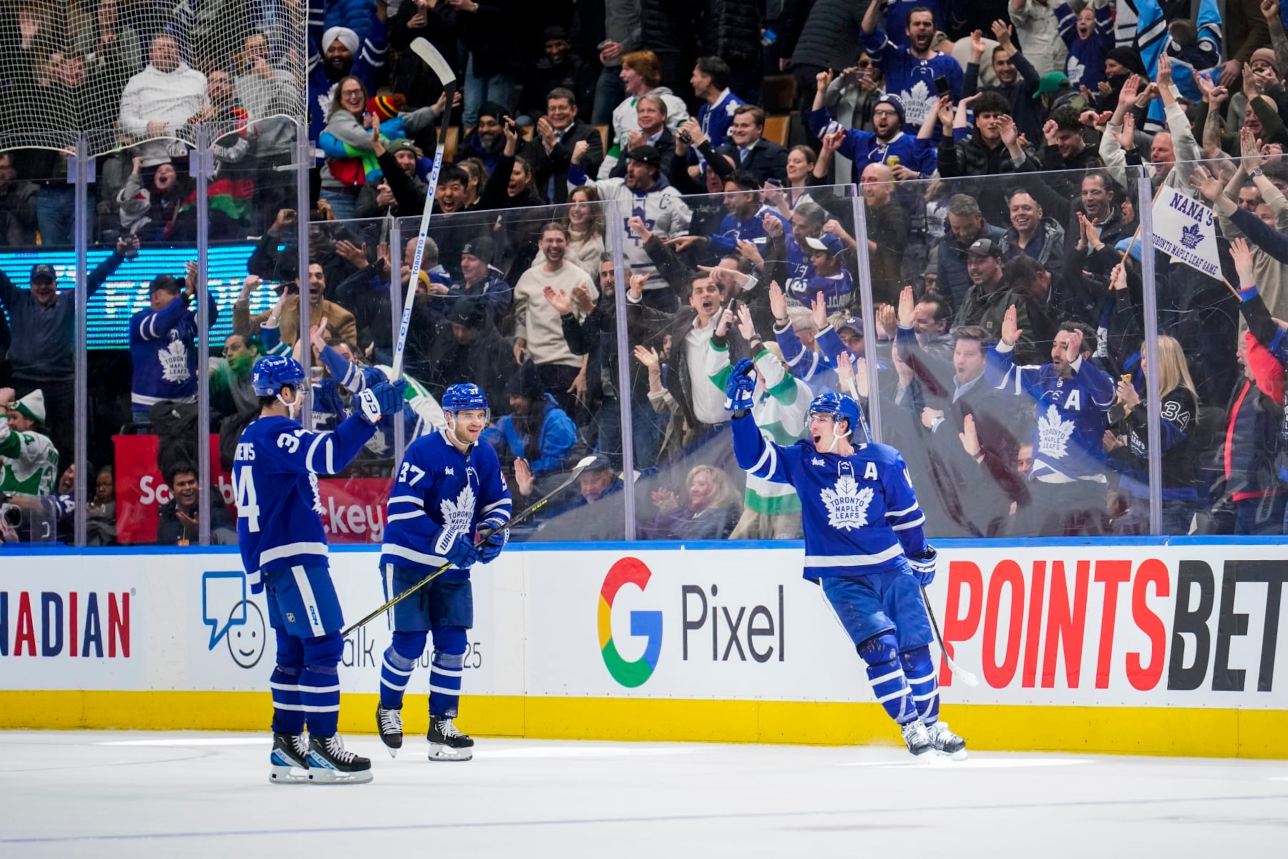 TORONTO, ON - JANUARY 25: Mitchell Marner #16 of the Toronto Maple Leafs celebrates his game winning goal against the New York Rangers with team-mates Timothy Liljegren #37  and Auston Matthews #34 at the Scotiabank Arena on January 25, 2023 in Toronto, Ontario, Canada. (Photo by Andrew Lahodynskyj/NHLI via Getty Images)