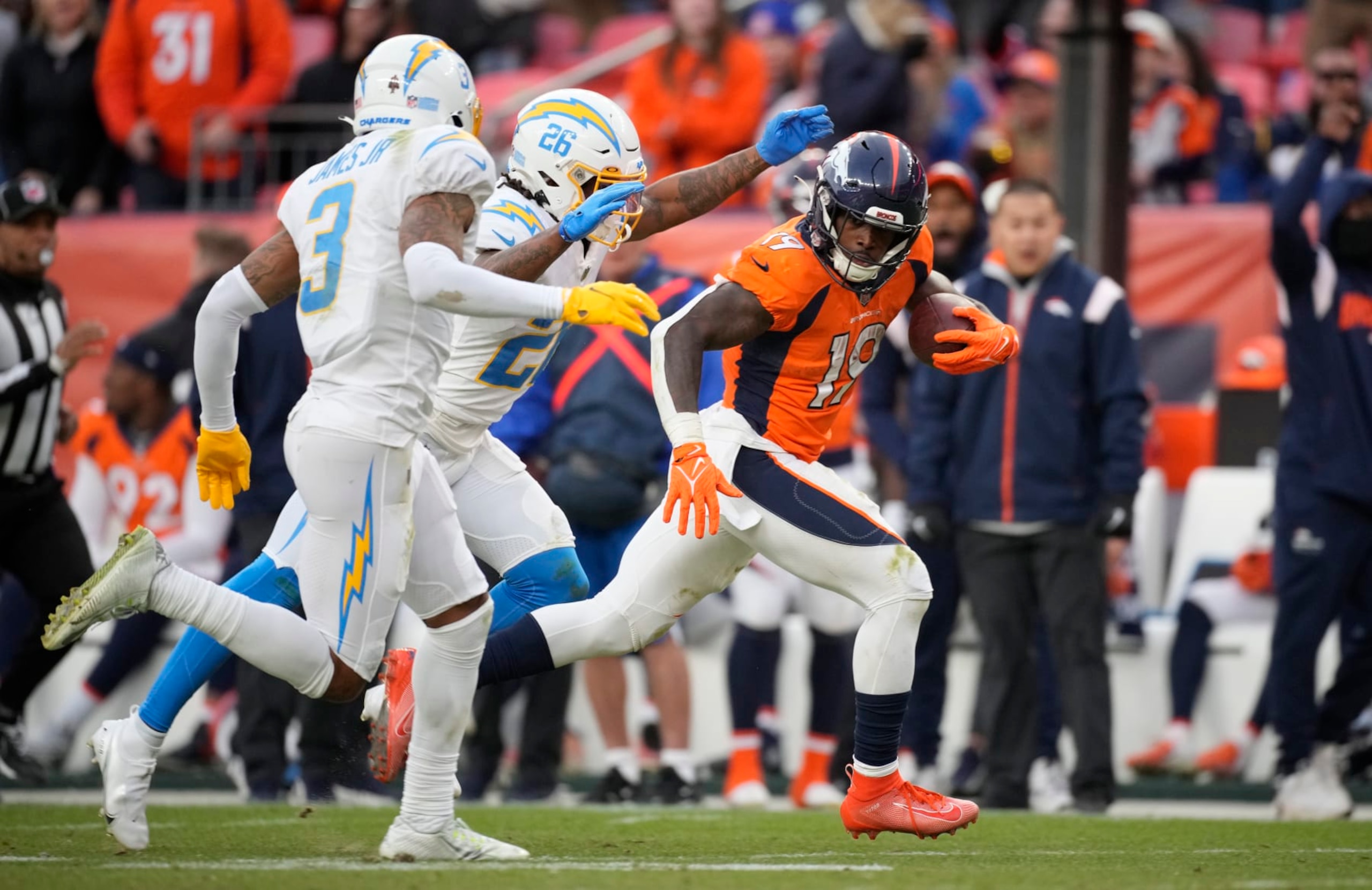 Denver Broncos running back Chase Edmonds (19) runds past Los Angeles Chargers in an NFL football game Sunday, Jan. 8, 2023, in Denver. (AP Photo/David Zalubowski)