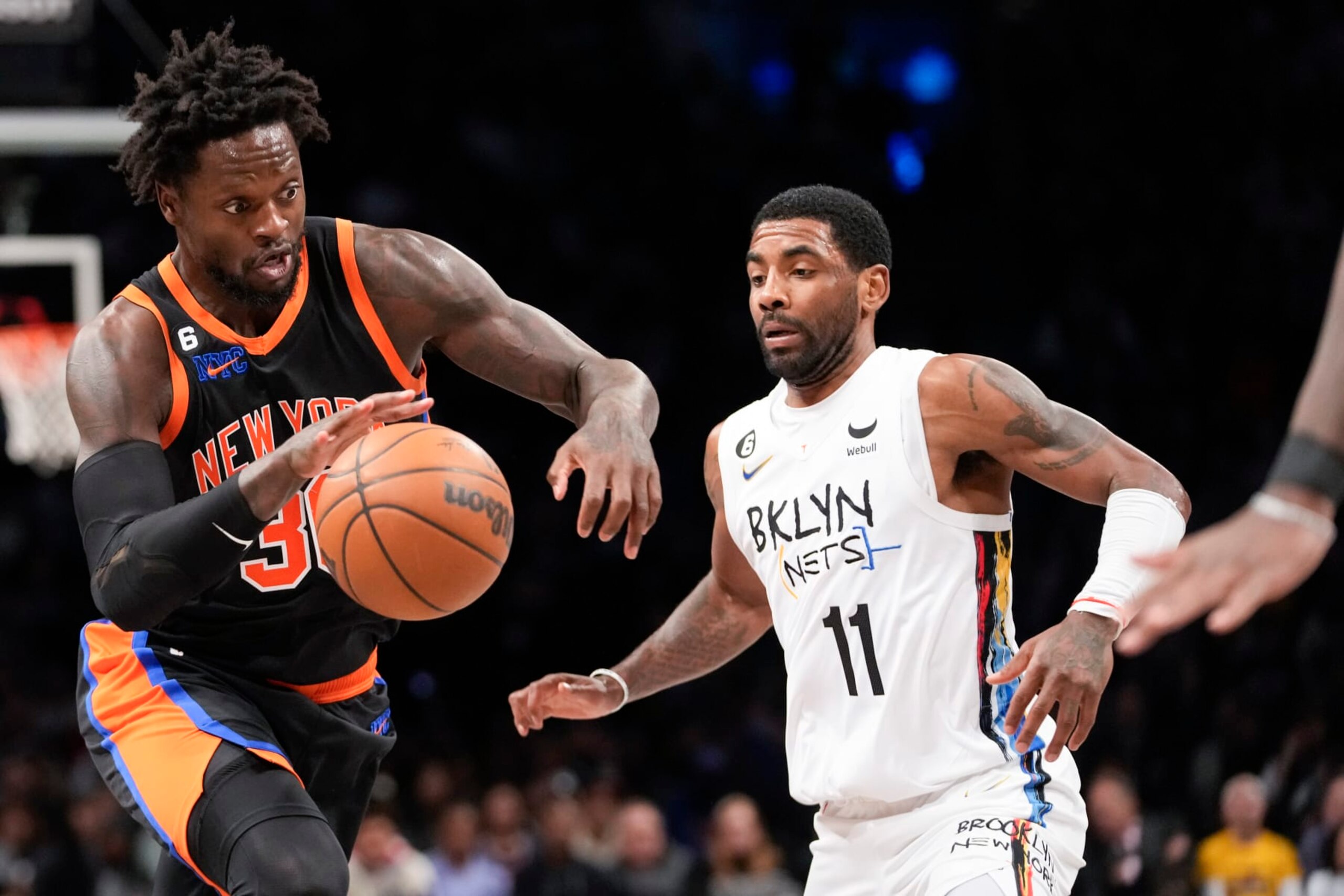 New York Knicks forward Julius Randle drives against Brooklyn Nets guard Kyrie Irving (11) during the first half of an NBA basketball game, Saturday, Jan. 28, 2023, in New York. (AP Photo/Mary Altaffer)
