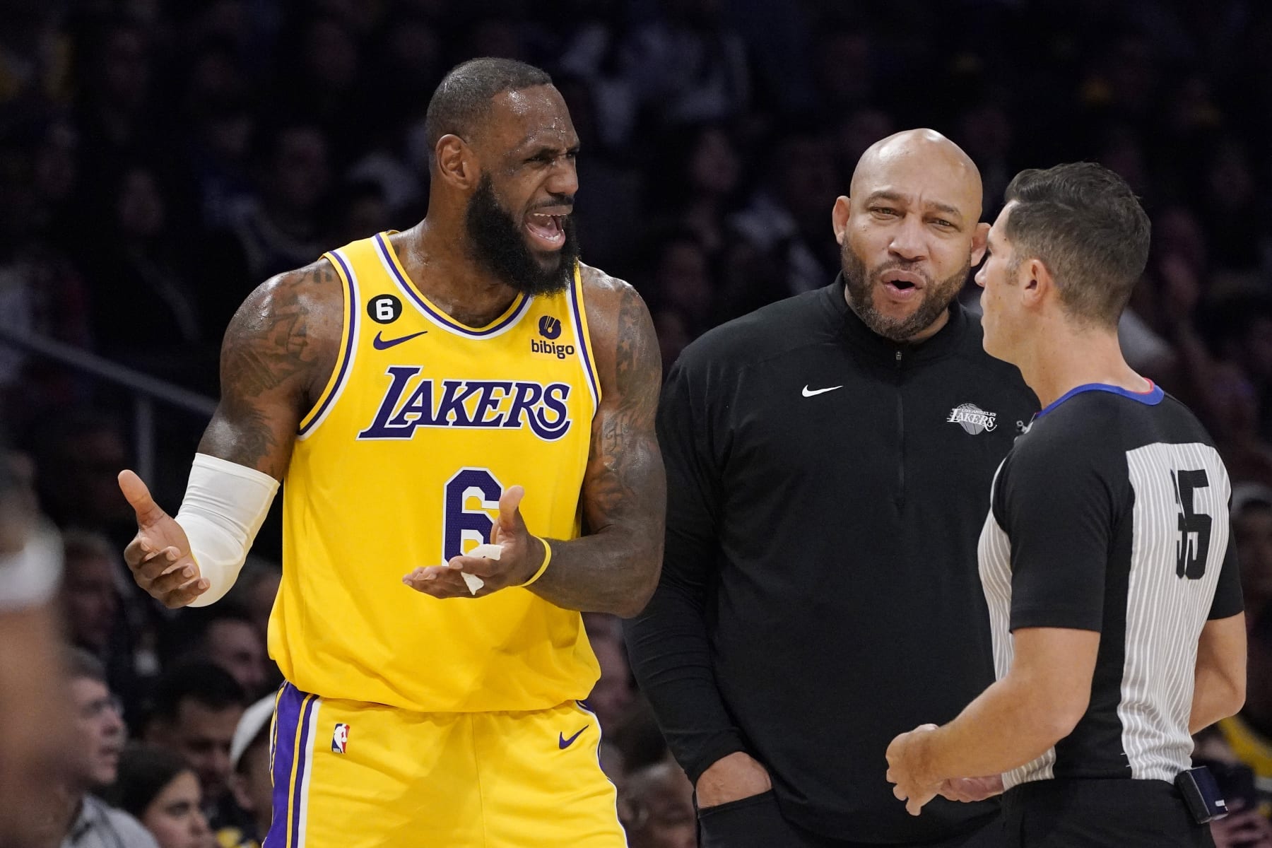 Los Angeles Lakers forward LeBron James, left, and head coach Darvin Ham, center, complain to referee Jason Goldenberg after a foul call during the second half of an NBA basketball game against the Los Angeles Clippers Tuesday, Jan. 24, 2023, in Los Angeles. (AP Photo/Mark J. Terrill)