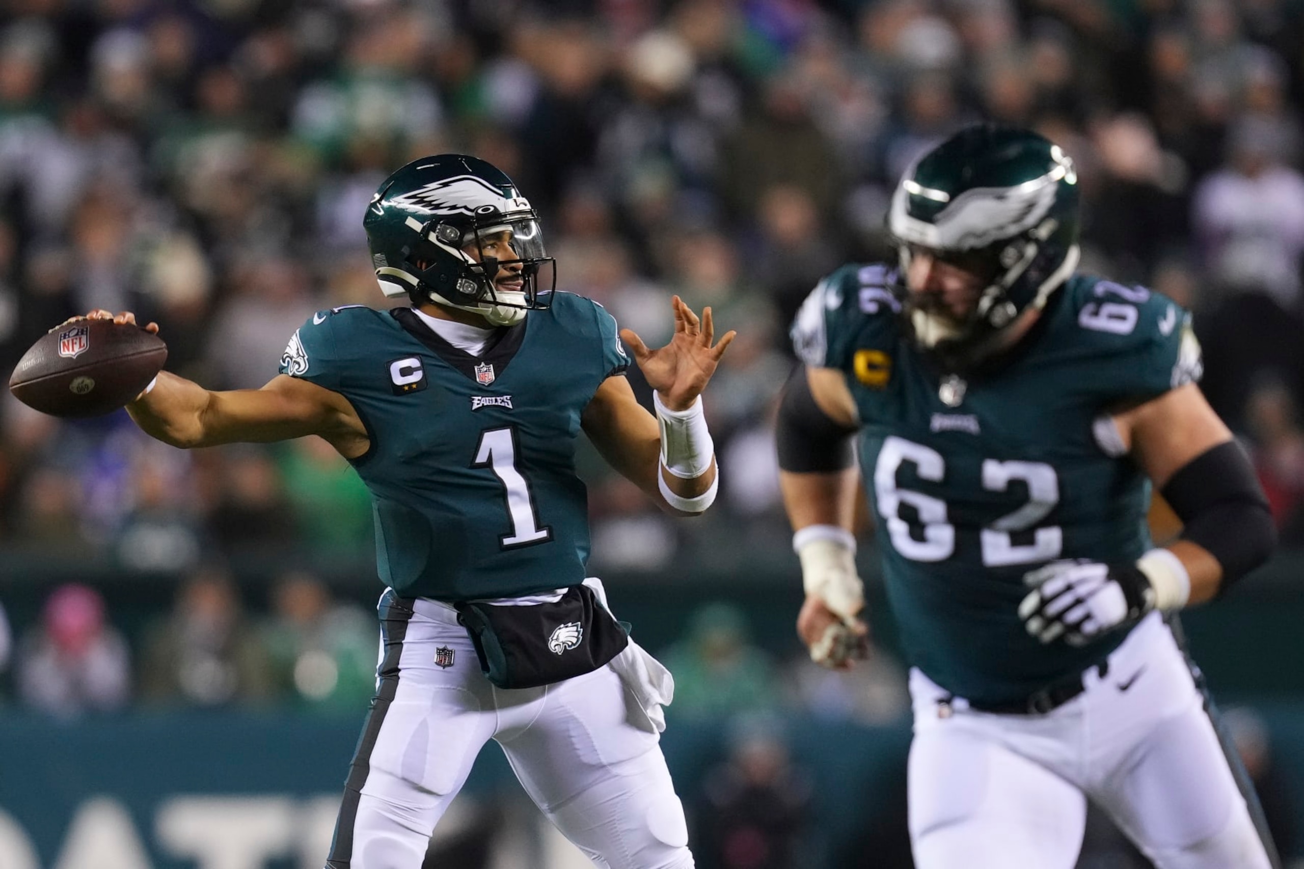 PHILADELPHIA, PA - JANUARY 21: Jalen Hurts #1 of the Philadelphia Eagles passes the ball as Jason Kelce #62 blocks against the New York Giants during the NFC Divisional Playoff game at Lincoln Financial Field on January 21, 2023 in Philadelphia, Pennsylvania. (Photo by Mitchell Leff/Getty Images)