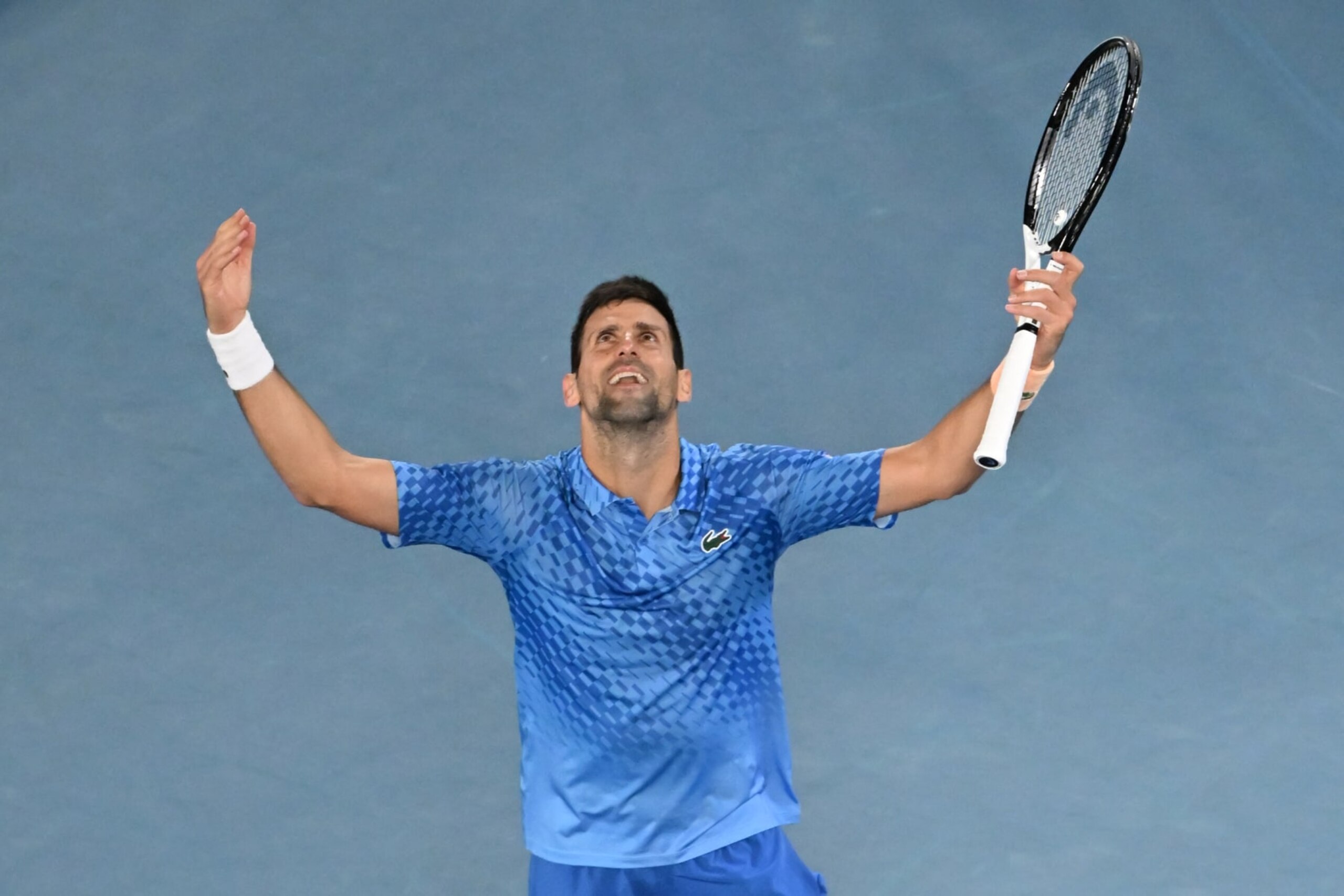 Serbia's Novak Djokovic celebrates his victory against Greece's Stefanos Tsitsipas during the men's singles final on day fourteen of the Australian Open tennis tournament in Melbourne on January 29, 2023. - -- IMAGE RESTRICTED TO EDITORIAL USE - STRICTLY NO COMMERCIAL USE -- (Photo by Paul CROCK / AFP) / -- IMAGE RESTRICTED TO EDITORIAL USE - STRICTLY NO COMMERCIAL USE -- (Photo by PAUL CROCK/AFP via Getty Images) Serbia's Novak Djokovic celebrates his victory against Greece's Stefanos Tsitsipas during the men's singles final on day fourteen of the Australian Open tennis tournament in Melbourne on January 29, 2023. - -- IMAGE RESTRICTED TO EDITORIAL USE - STRICTLY NO COMMERCIAL USE -- (Photo by Paul CROCK / AFP) / -- IMAGE RESTRICTED TO EDITORIAL USE - STRICTLY NO COMMERCIAL USE -- (Photo by PAUL CROCK/AFP via Getty Images)