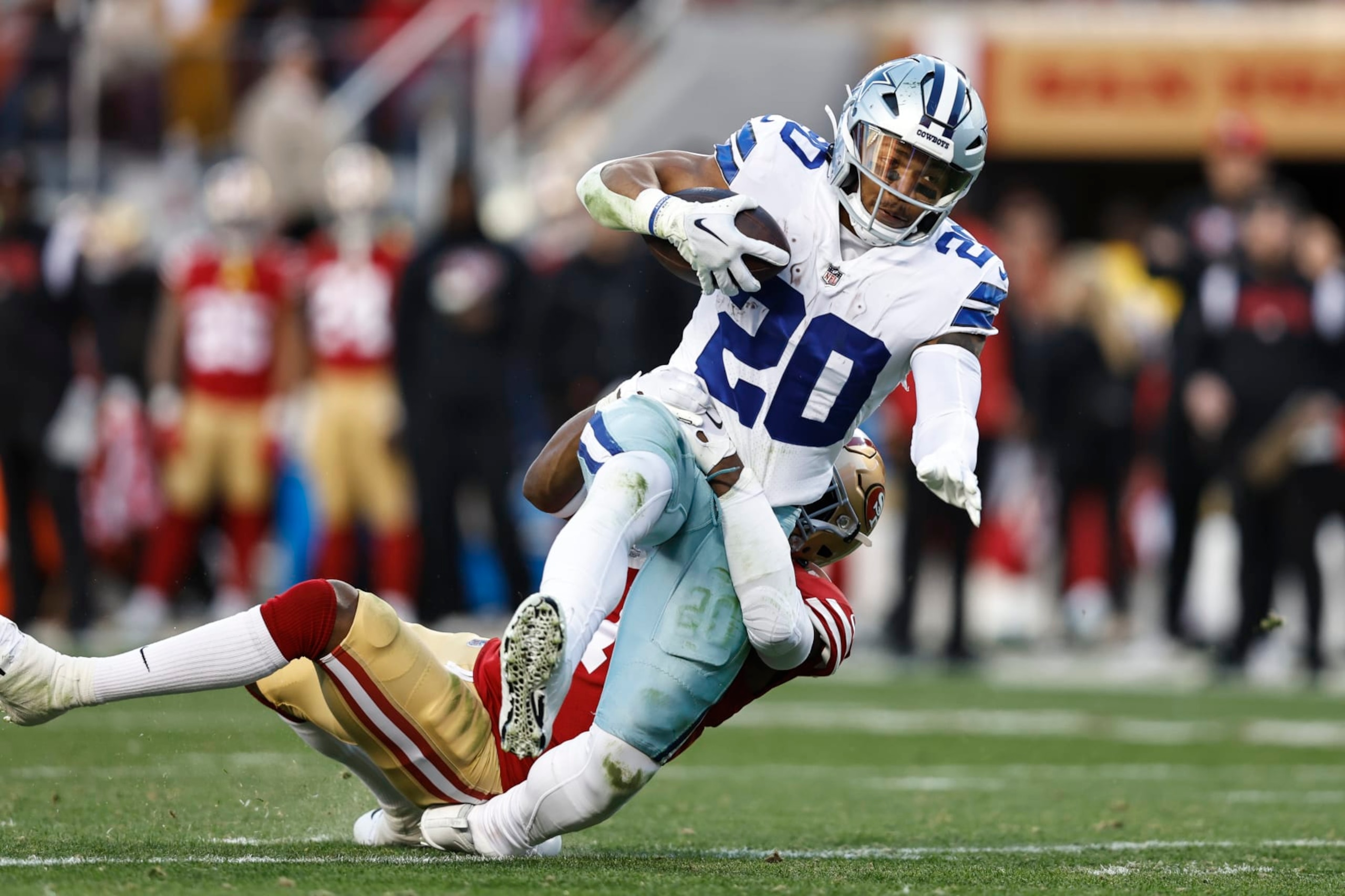 SANTA CLARA, CALIFORNIA - JANUARY 22: Tony Pollard #20 of the Dallas Cowboys is tackled by Jimmie Ward #1 of the San Francisco 49ers as he runs with the ball and gets injured during an NFL divisional round playoff football game between the San Francisco 49ers and the Dallas Cowboys at Levi's Stadium on January 22, 2023 in Santa Clara, California. (Photo by Michael Owens/Getty Images)