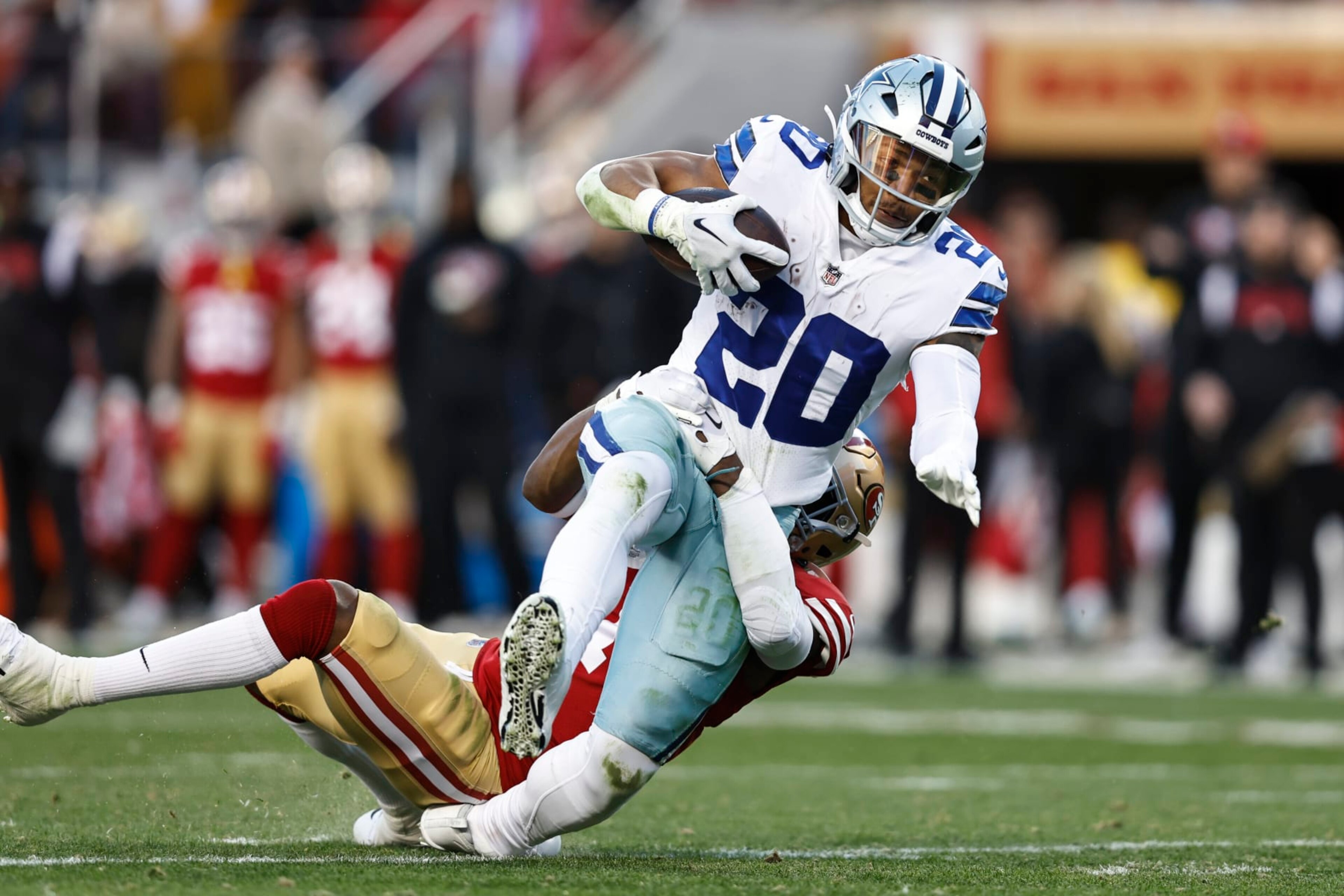 SANTA CLARA, CALIFORNIA - JANUARY 22: Tony Pollard #20 of the Dallas Cowboys is tackled by Jimmie Ward #1 of the San Francisco 49ers as he runs with the ball and gets injured during an NFL divisional round playoff football game between the San Francisco 49ers and the Dallas Cowboys at Levi's Stadium on January 22, 2023 in Santa Clara, California. (Photo by Michael Owens/Getty Images)