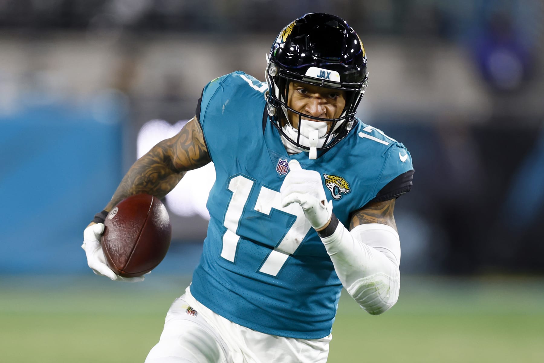 JACKSONVILLE, FLORIDA - JANUARY 14: Evan Engram #17 of the Jacksonville Jaguars carries the ball against the Los Angeles Chargers during the second half of the game in the AFC Wild Card playoff game at TIAA Bank Field on January 14, 2023 in Jacksonville, Florida. (Photo by Douglas P. DeFelice/Getty Images)
