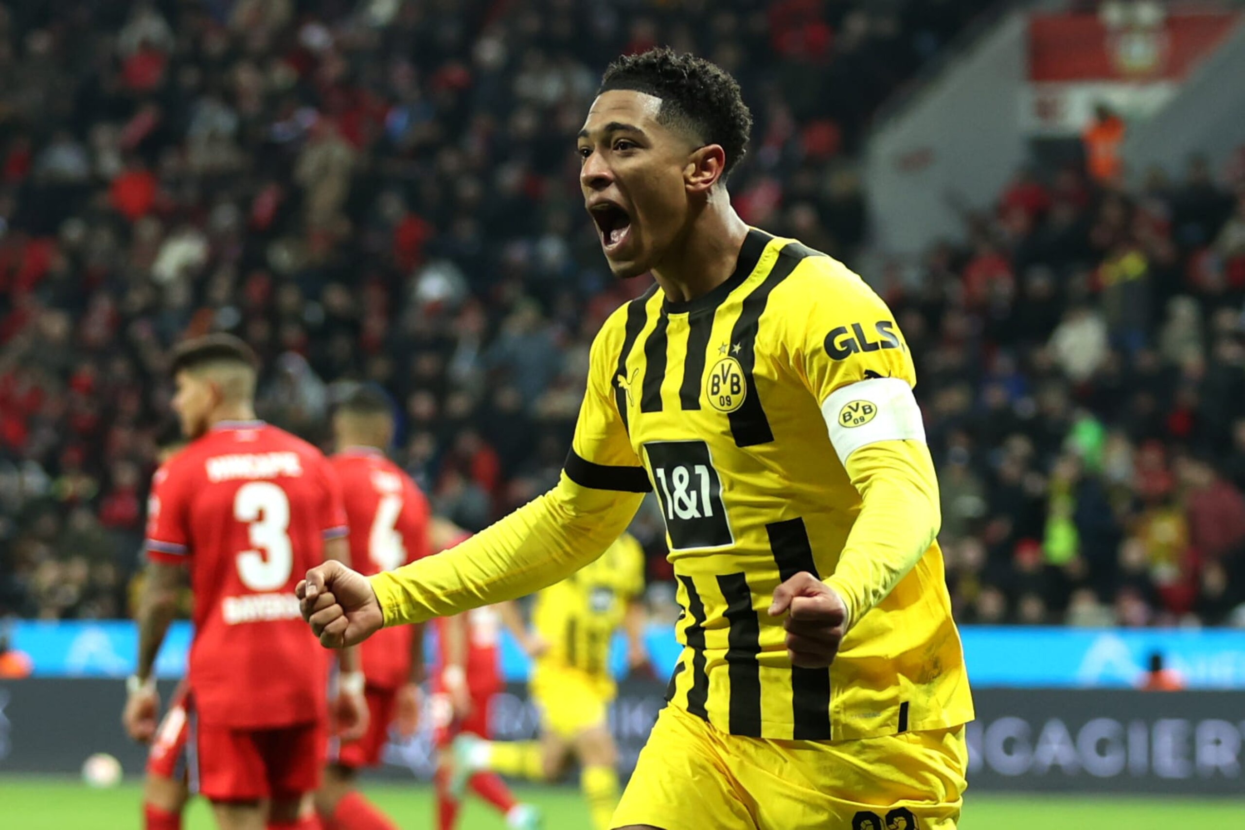 LEVERKUSEN, GERMANY - JANUARY 29: Jude Bellingham of Borussia Dortmund celebrates after an own goal by Edmond Tapsoba of Bayer 04 Leverkusen (not pictured), Borussia Dortmund's second goal during the Bundesliga match between Bayer 04 Leverkusen and Borussia Dortmund at BayArena on January 29, 2023 in Leverkusen, Germany. (Photo by Lars Baron/Getty Images)