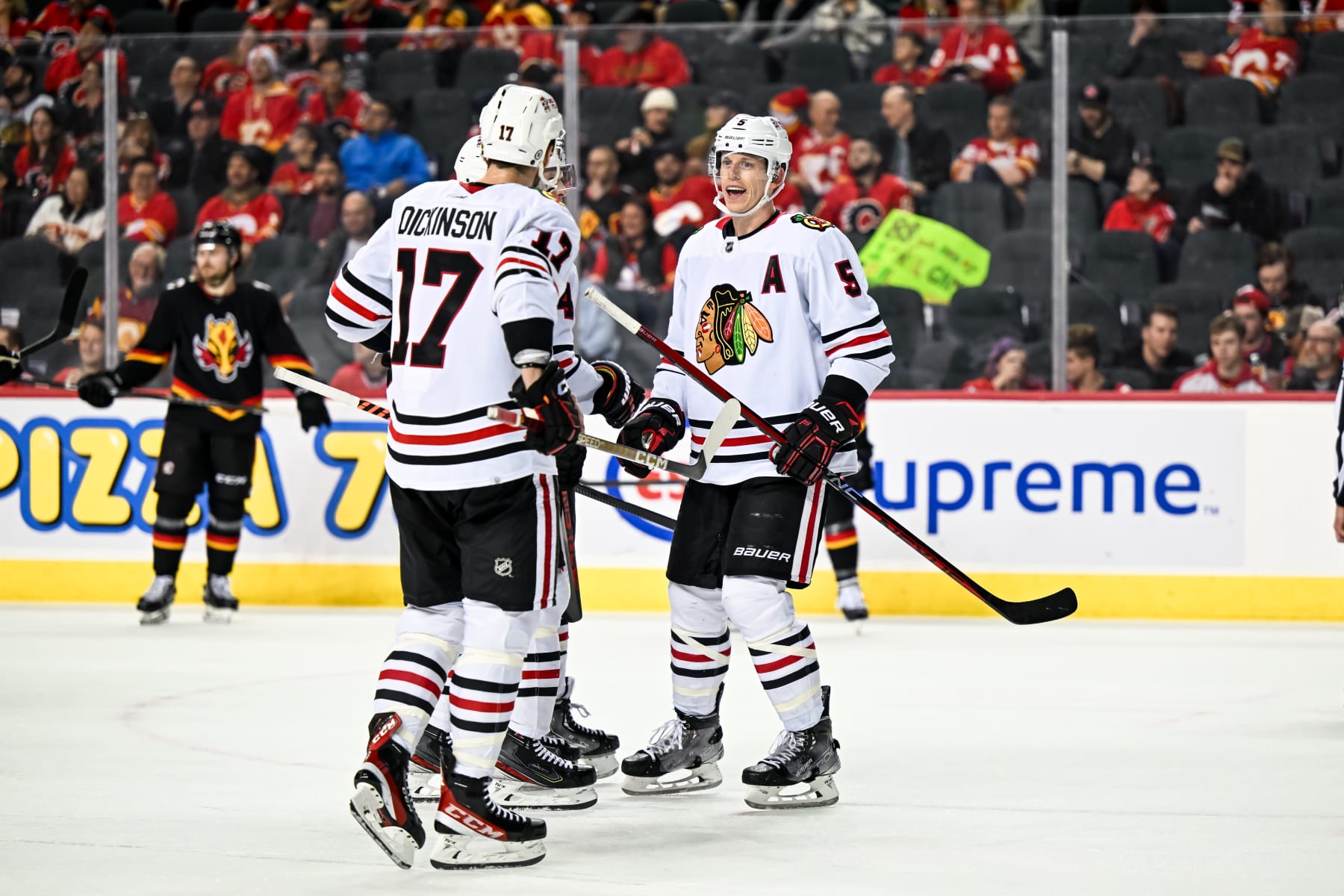 CALGARY, AB - JANUARY 26: Chicago Blackhawks Defenceman Connor Murphy (5), Chicago Blackhawks Left Wing Jason Dickinson (17) and Chicago Blackhawks Defenceman Seth Jones (4) talk strategy during the third period of an NHL game between the Calgary Flames and the Chicago Blackhawks on January 26, 2023, at the Scotiabank Saddledome in Calgary, AB. (Photo by Brett Holmes/Icon Sportswire via Getty Images)
