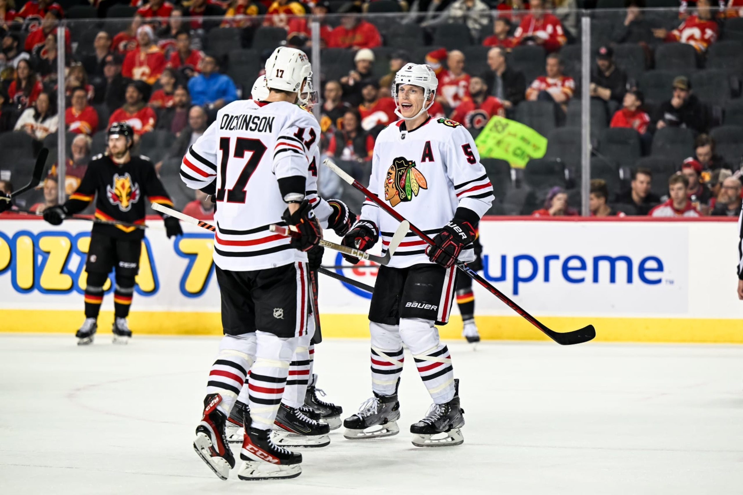 CALGARY, AB - JANUARY 26: Chicago Blackhawks Defenceman Connor Murphy (5), Chicago Blackhawks Left Wing Jason Dickinson (17) and Chicago Blackhawks Defenceman Seth Jones (4) talk strategy during the third period of an NHL game between the Calgary Flames and the Chicago Blackhawks on January 26, 2023, at the Scotiabank Saddledome in Calgary, AB. (Photo by Brett Holmes/Icon Sportswire via Getty Images)