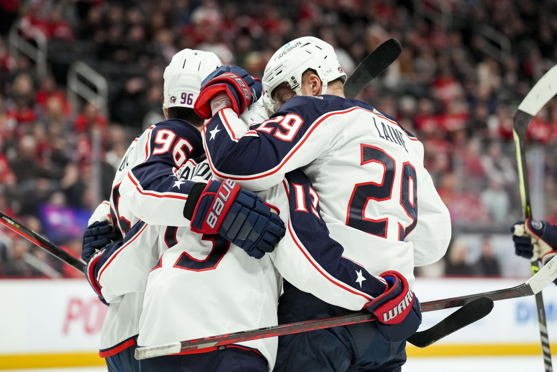 DETROIT, MICHIGAN - JANUARY 14: Jack Roslovic #96, Johnny Gaudreau #13 and Patrik Laine #29 of the Columbus Blue Jackets celebrate a goal scored by Laine against the Detroit Red Wings during the first period of the game at Little Caesars Arena on January 14, 2023 in Detroit, Michigan. (Photo by Nic Antaya/Getty Images)