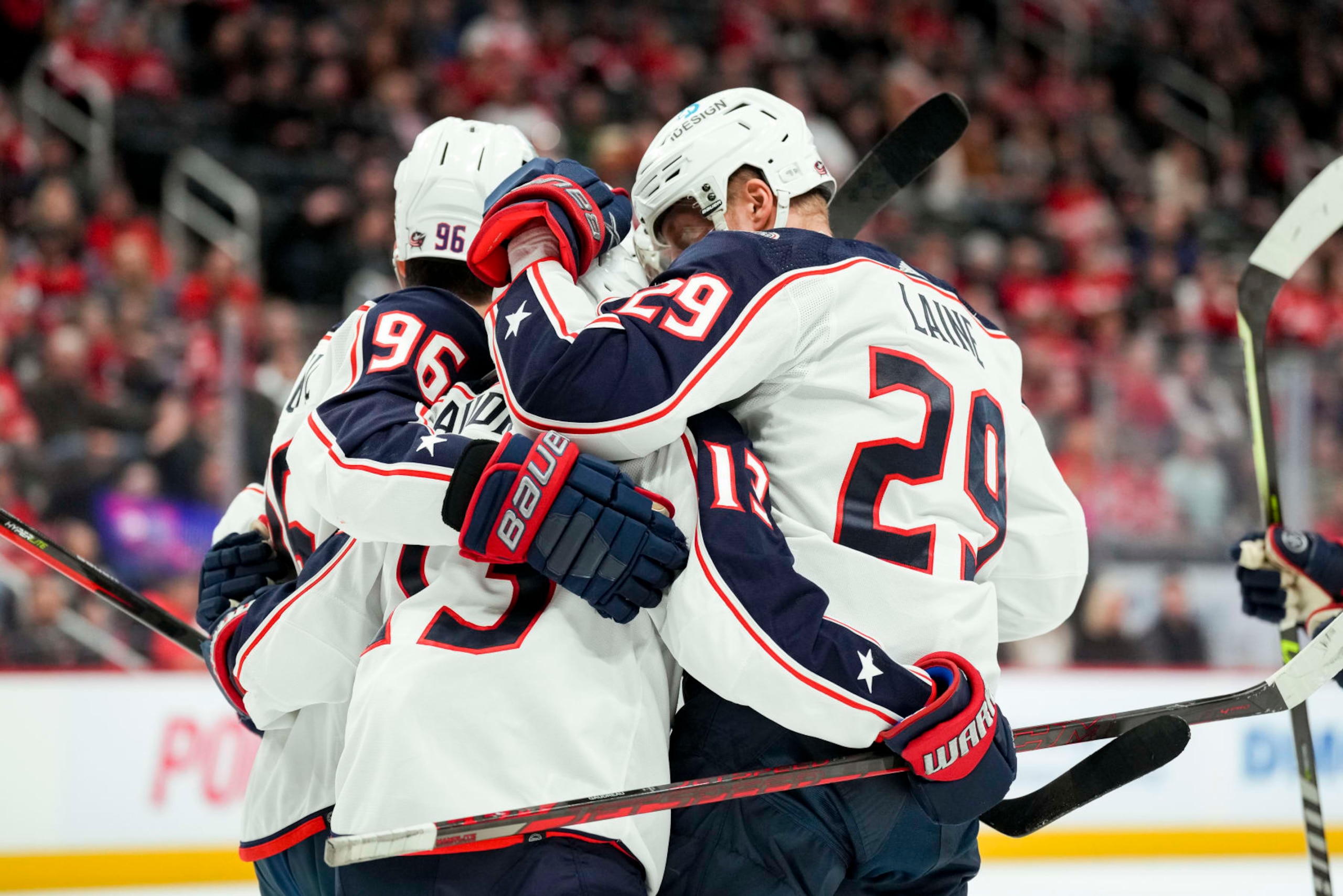 DETROIT, MICHIGAN - JANUARY 14: Jack Roslovic #96, Johnny Gaudreau #13 and Patrik Laine #29 of the Columbus Blue Jackets celebrate a goal scored by Laine against the Detroit Red Wings during the first period of the game at Little Caesars Arena on January 14, 2023 in Detroit, Michigan. (Photo by Nic Antaya/Getty Images)