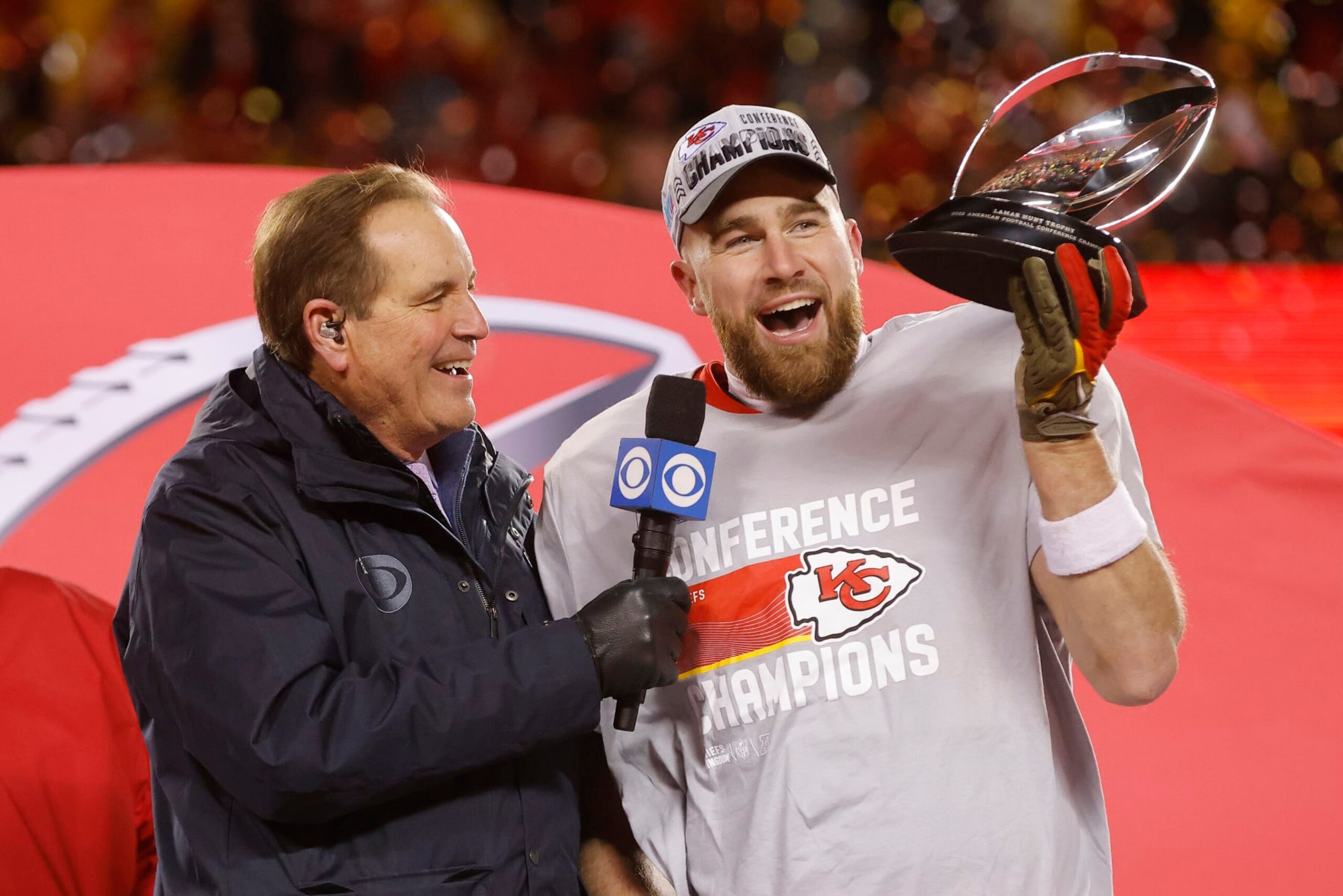 KANSAS CITY, MISSOURI - JANUARY 29: Travis Kelce #87 of the Kansas City Chiefs holds up the Lamar Hunt Trophy after defeating the Cincinnati Bengals 23-20 in the AFC Championship Game at GEHA Field at Arrowhead Stadium on January 29, 2023 in Kansas City, Missouri. (Photo by David Eulitt/Getty Images)