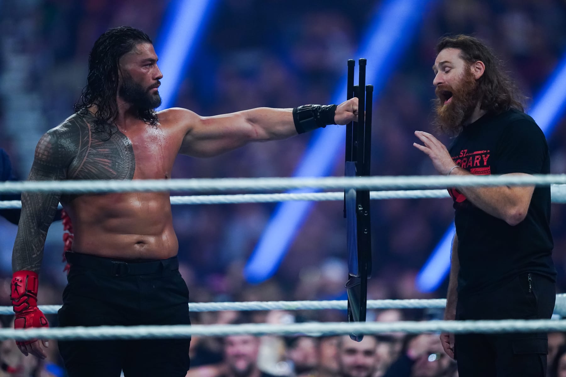 SAN ANTONIO, TEXAS - JANUARY 28: Roman Reigns and Sami Zayn talk during the WWE and Universal Championship match during the WWE Royal Rumble event the Alamodome on January 28, 2023 in San Antonio, Texas. (Photo by Alex Bierens de Haan/Getty Images)