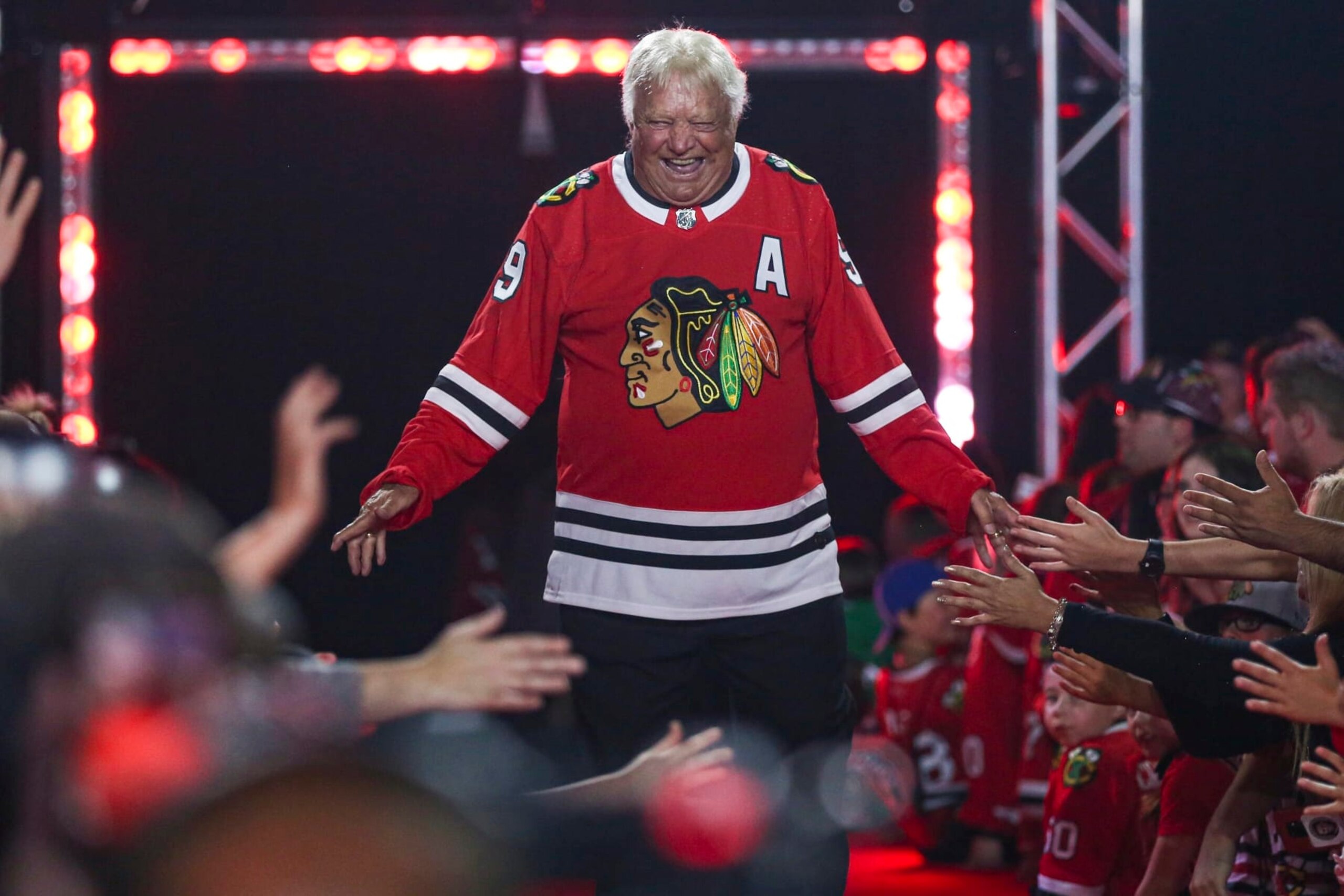 FILE - Former Chicago Blackhawks player Bobby Hull is introduced to fans during the NHL hockey team's convention in Chicago, Friday, July 26, 2019. Hall of Fame forward Bobby Hull is no longer serving as a team ambassador for the Chicago Blackhawks. "When it comes to Bobby, specifically, we jointly agreed earlier this season that he will retire from any official team role,” the team said in a statement Monday, Feb. 21, 2022. (AP Photo/Amr Alfiky, File)