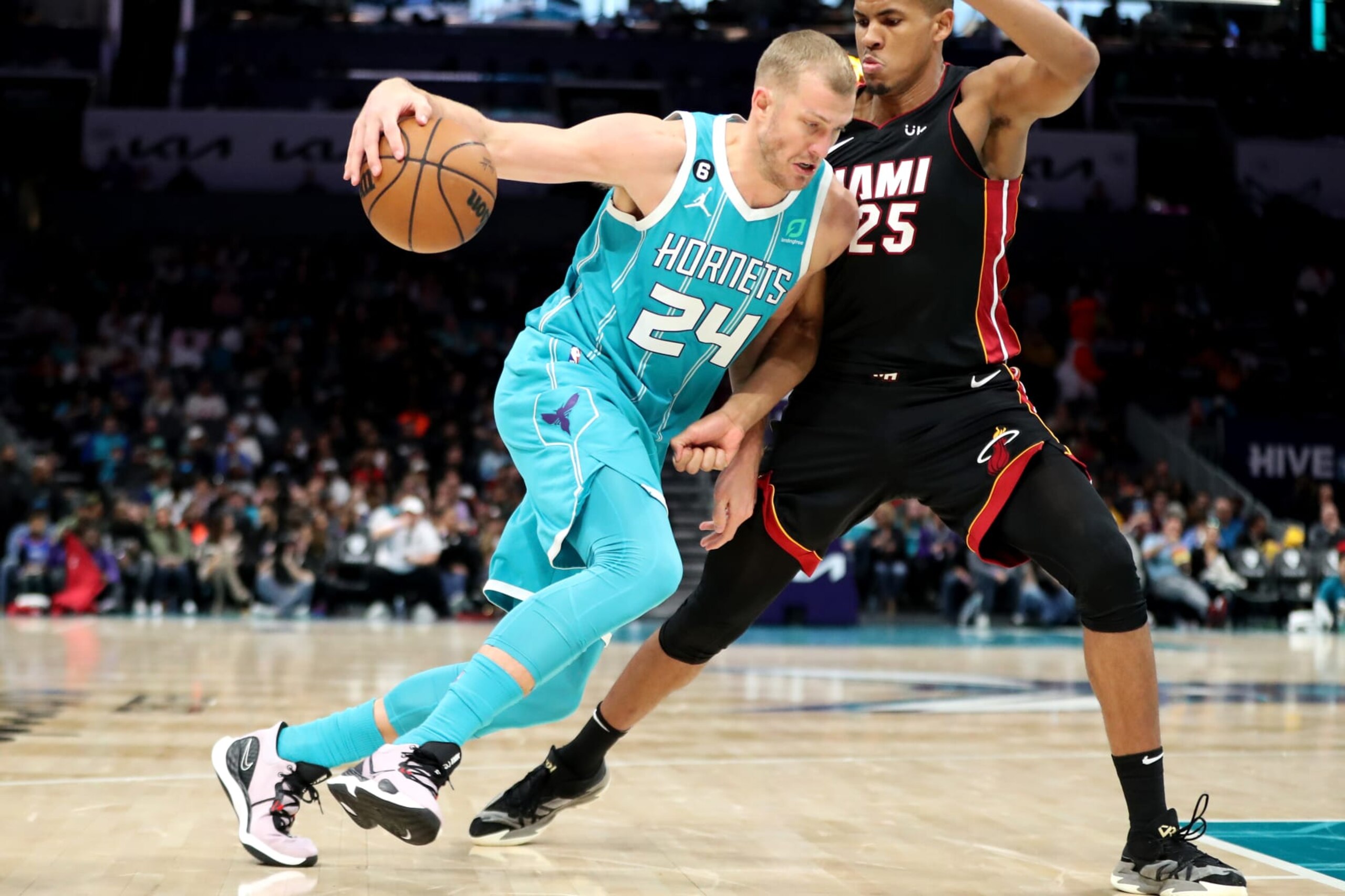 CHARLOTTE, NORTH CAROLINA - JANUARY 29: Mason Plumlee #24 of the Charlotte Hornets drives to the basket while being defended by Orlando Robinson #25 of the Miami Heat during the second quarter of a basketball game at Spectrum Center on January 29, 2023 in Charlotte, North Carolina. NOTE TO USER: User expressly acknowledges and agrees that, by downloading and or using this photograph, User is consenting to the terms and conditions of the Getty Images License Agreement. (Photo by David Jensen/Getty Images)
