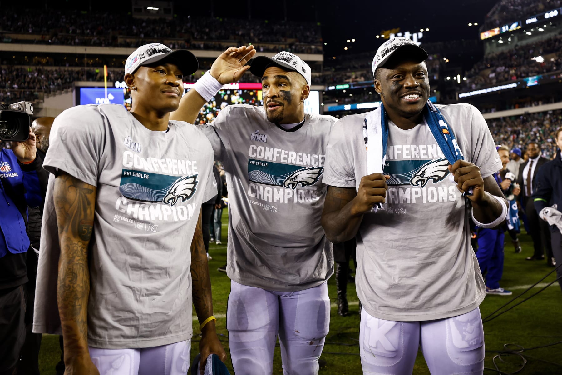 PHILADELPHIA, PA - JANUARY 29: DeVonta Smith #6, Jalen Hurts #1, and A.J. Brown #11 of the Philadelphia Eagles smile on the field after the Philadelphia Eagles beat the San Francisco 49ers in the NFC Championship NFL football game at Lincoln Financial Field on January 29, 2023 in Philadelphia, Pennsylvania. (Photo by Kevin Sabitus/Getty Images)