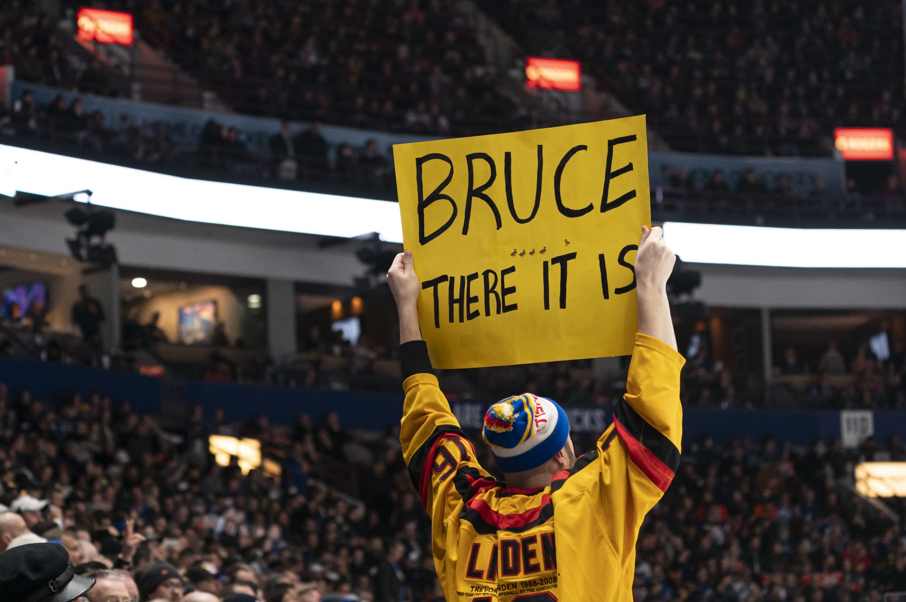 VANCOUVER, CANADA - JANUARY 21:  A fan holds up a sign in support of Bruce Boudreau head coach of the Vancouver Canucks during NHL action between the Vancouver Canucks and the Edmonton Oilers on January, 21, 2023 at Rogers Arena in Vancouver, British Columbia, Canada.  (Photo by Rich Lam/Getty Images)