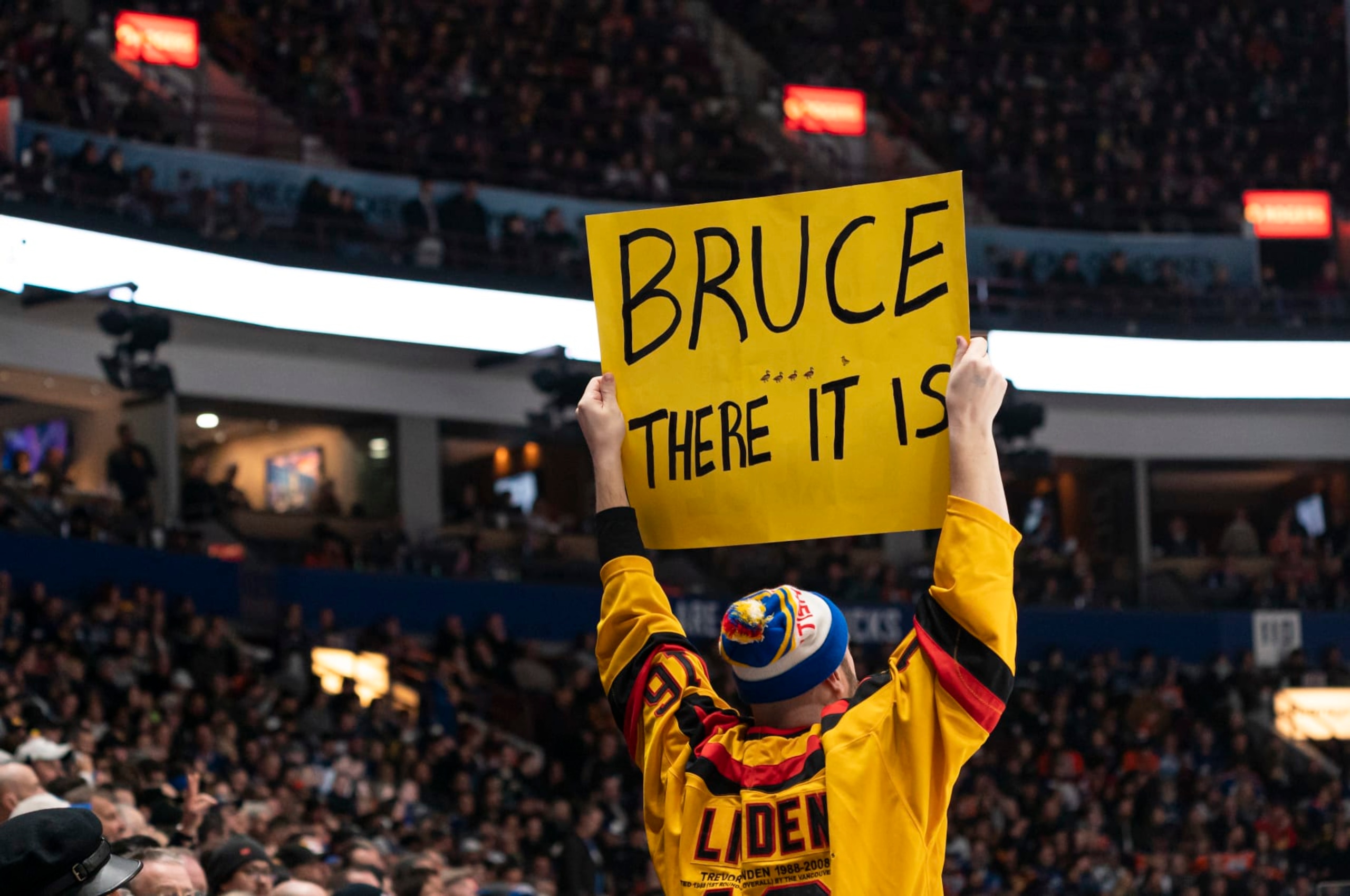 VANCOUVER, CANADA - JANUARY 21:  A fan holds up a sign in support of Bruce Boudreau head coach of the Vancouver Canucks during NHL action between the Vancouver Canucks and the Edmonton Oilers on January, 21, 2023 at Rogers Arena in Vancouver, British Columbia, Canada.  (Photo by Rich Lam/Getty Images)