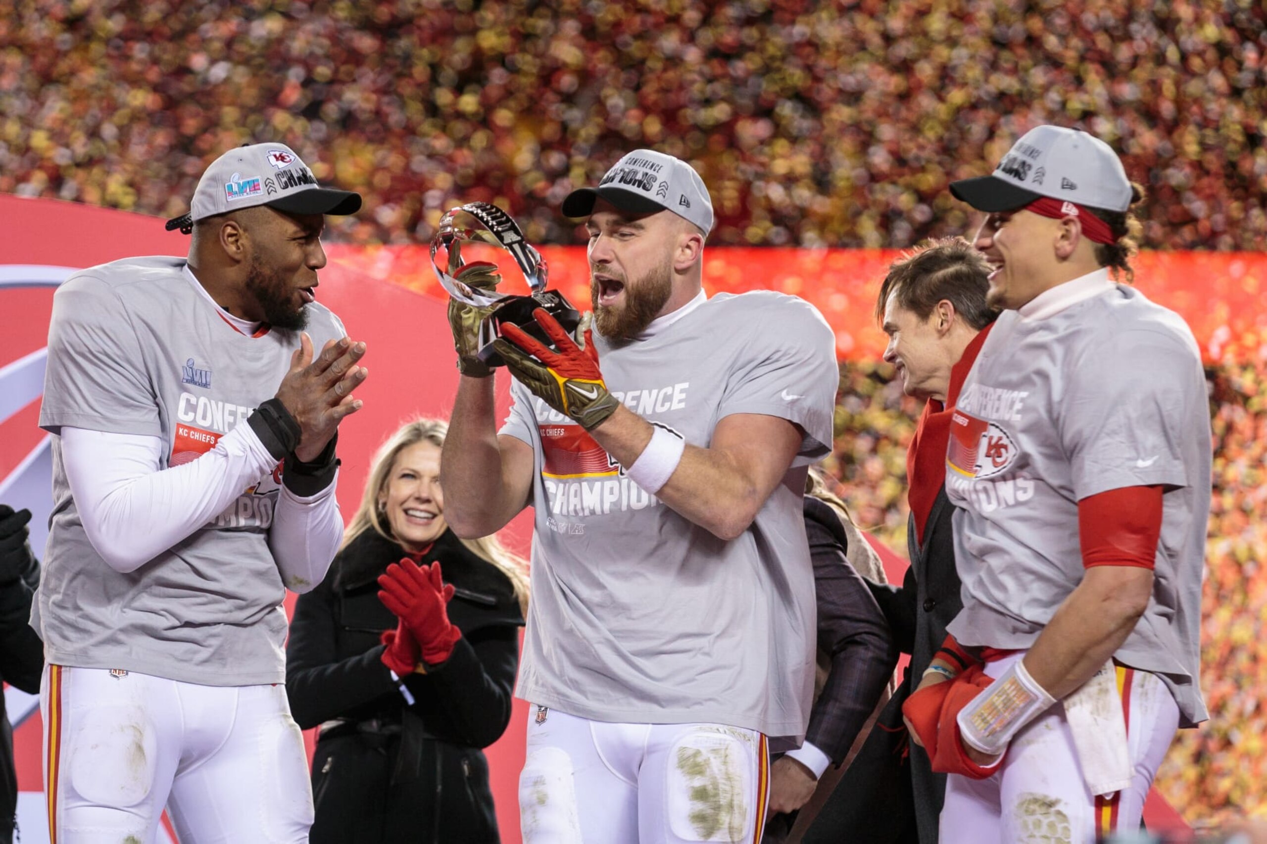 KANSAS CITY, MO - JANUARY 29: Kansas City Chiefs tight end Travis Kelce (87) Kansas City Chiefs quarterback Patrick Mahomes (15) and Kansas City Chiefs defensive end Carlos Dunlap (8) look at the championship trophy after the game against the Cincinnati Bengals on January 29th, 2023 at Arrowhead Stadium in Kansas City, Missouri. (Photo by William Purnell/Icon Sportswire via Getty Images)
