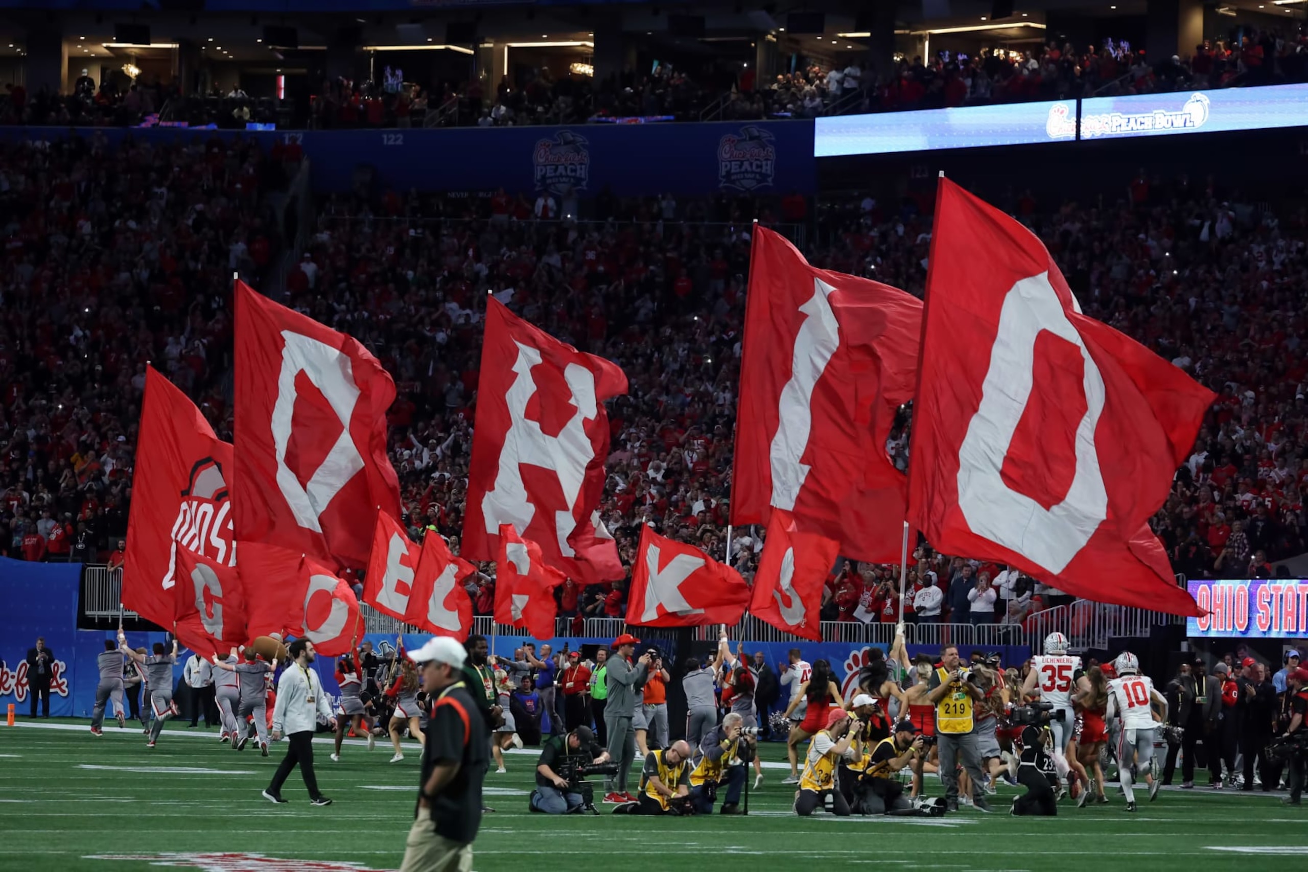 ATLANTA, GA - DECEMBER 31: The Ohio State Buckeyes run onto the field for the college football Playoff Semifinal game at the Chick-fil-a Peach Bowl between the Georgia Bulldogs and the Ohio State Buckeyes on December 31, 2022 at Mercedes-Benz Stadium in Atlanta, Georgia. (Photo by Michael Wade/Icon Sportswire via Getty Images) ATLANTA, GA - DECEMBER 31: The Ohio State Buckeyes run onto the field for the college football Playoff Semifinal game at the Chick-fil-a Peach Bowl between the Georgia Bulldogs and the Ohio State Buckeyes on December 31, 2022 at Mercedes-Benz Stadium in Atlanta, Georgia. (Photo by Michael Wade/Icon Sportswire via Getty Images)