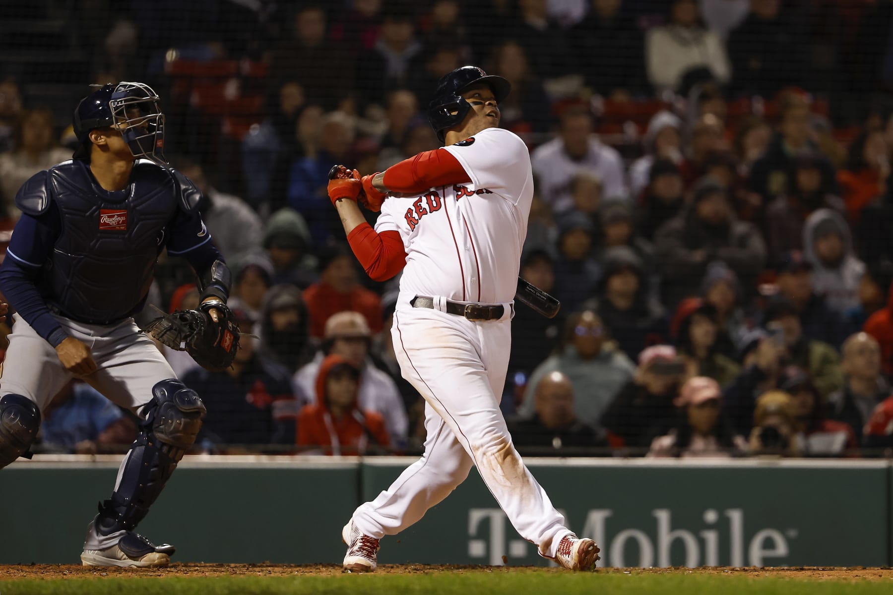 BOSTON, MA - OCTOBER 3: Rafael Devers #11 of the Boston Red Sox follows through on the go ahead RBI sacrifice fly during the seventh inning against the Tampa Bay Rays at Fenway Park on October 3, 2022 in Boston, Massachusetts. (Photo By Winslow Townson/Getty Images)