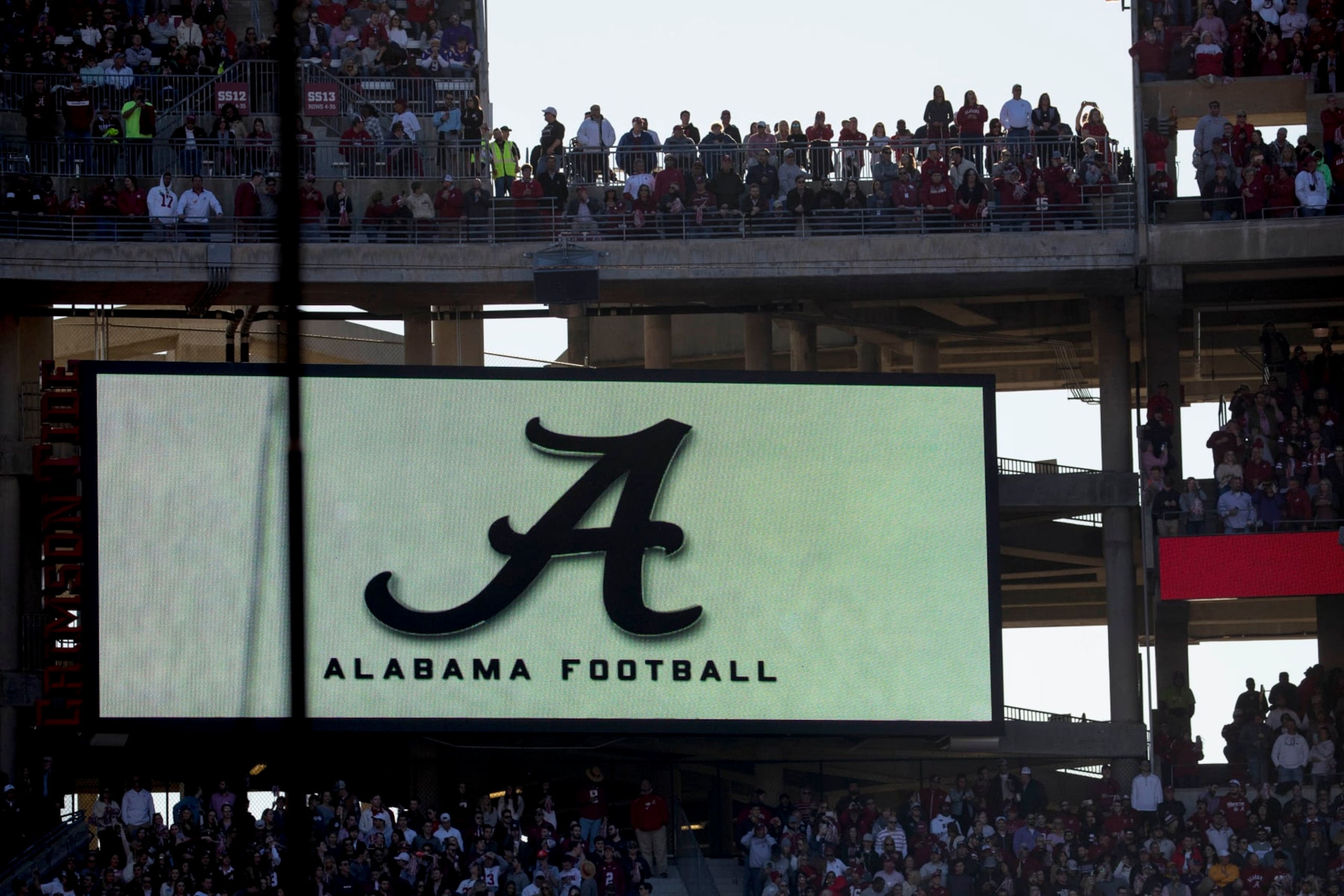 Fans stand before the start of an NCAA college football game between LSU and Alabama at Bryant-Denny Stadium, in Tuscaloosa, Ala., Saturday, Nov. 9, 2019. (AP Photo/Andrew Harnik)