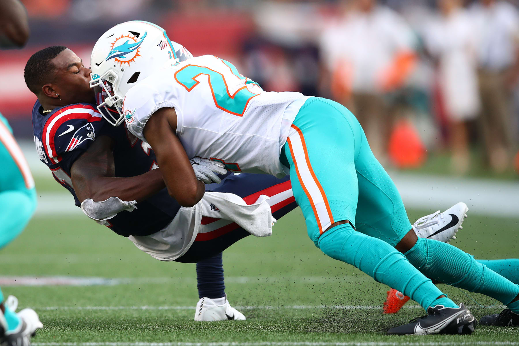 FOXBOROUGH, MASSACHUSETTS - SEPTEMBER 12: Damien Harris #37 of the New England Patriots is tackled by Byron Jones #24 of the Miami Dolphins during the first half at Gillette Stadium on September 12, 2021 in Foxborough, Massachusetts. (Photo by Adam Glanzman/Getty Images)