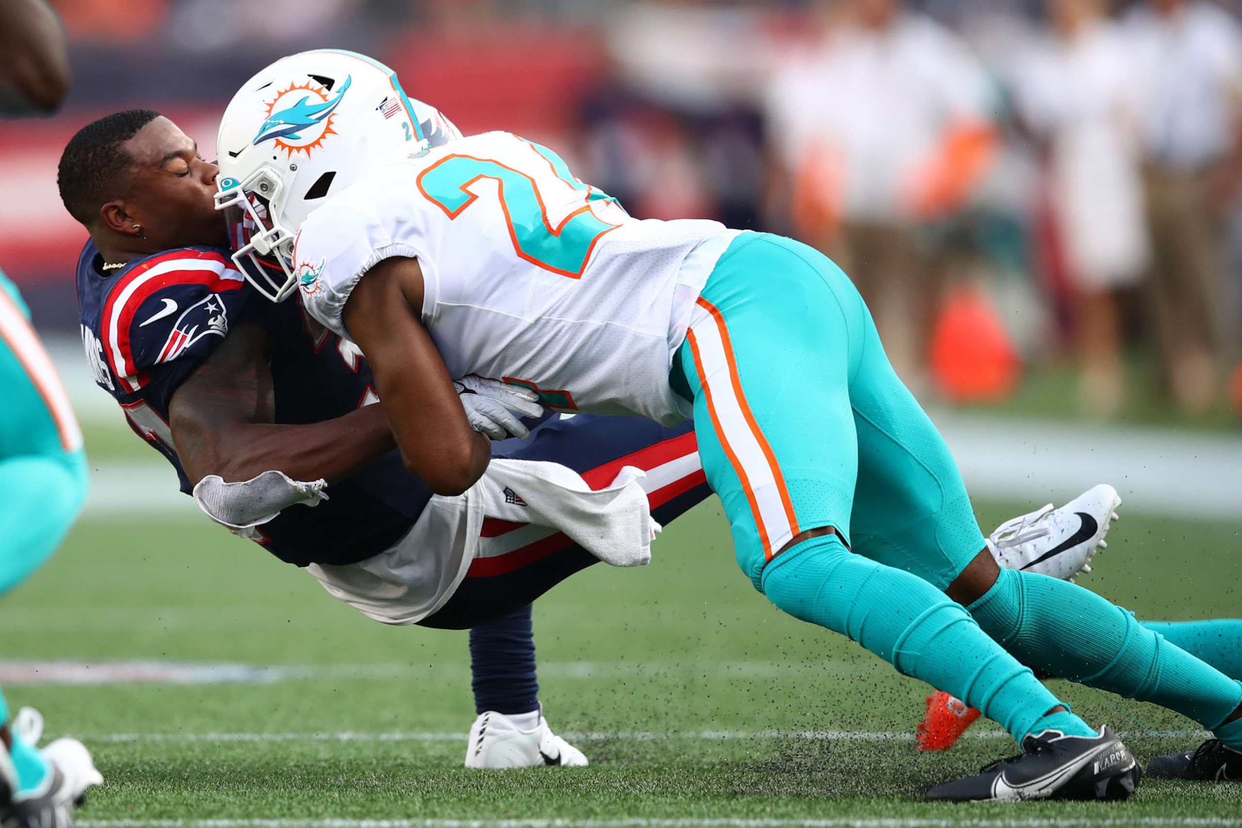FOXBOROUGH, MASSACHUSETTS - SEPTEMBER 12: Damien Harris #37 of the New England Patriots is tackled by Byron Jones #24 of the Miami Dolphins during the first half at Gillette Stadium on September 12, 2021 in Foxborough, Massachusetts. (Photo by Adam Glanzman/Getty Images)