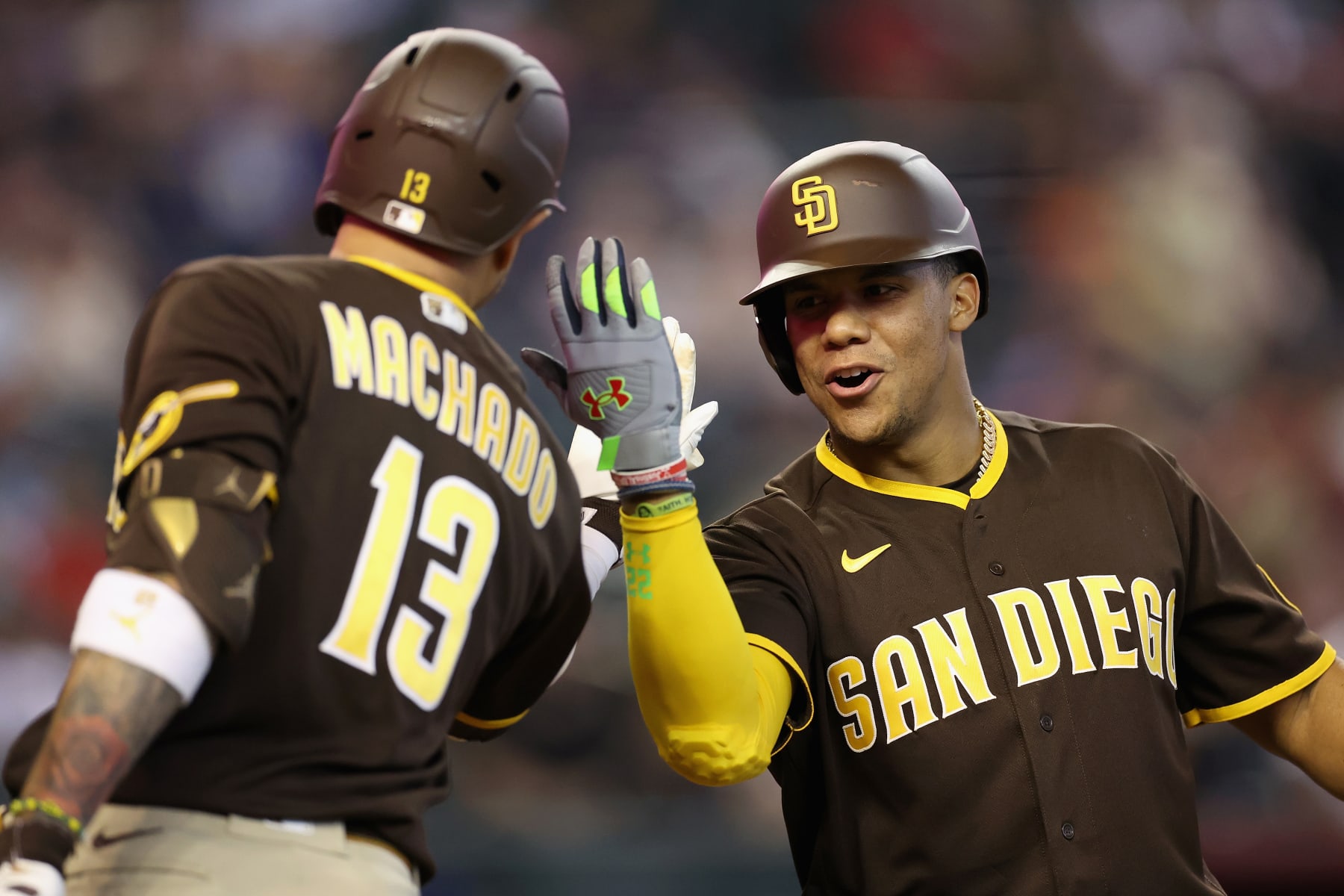 PHOENIX, ARIZONA - SEPTEMBER 18: Juan Soto #22 of the San Diego Padres high fives Manny Machado #13 after hitting a solo home run against the Arizona Diamondbacks during the fifth inning of the MLB game at Chase Field on September 18, 2022 in Phoenix, Arizona. (Photo by Christian Petersen/Getty Images)