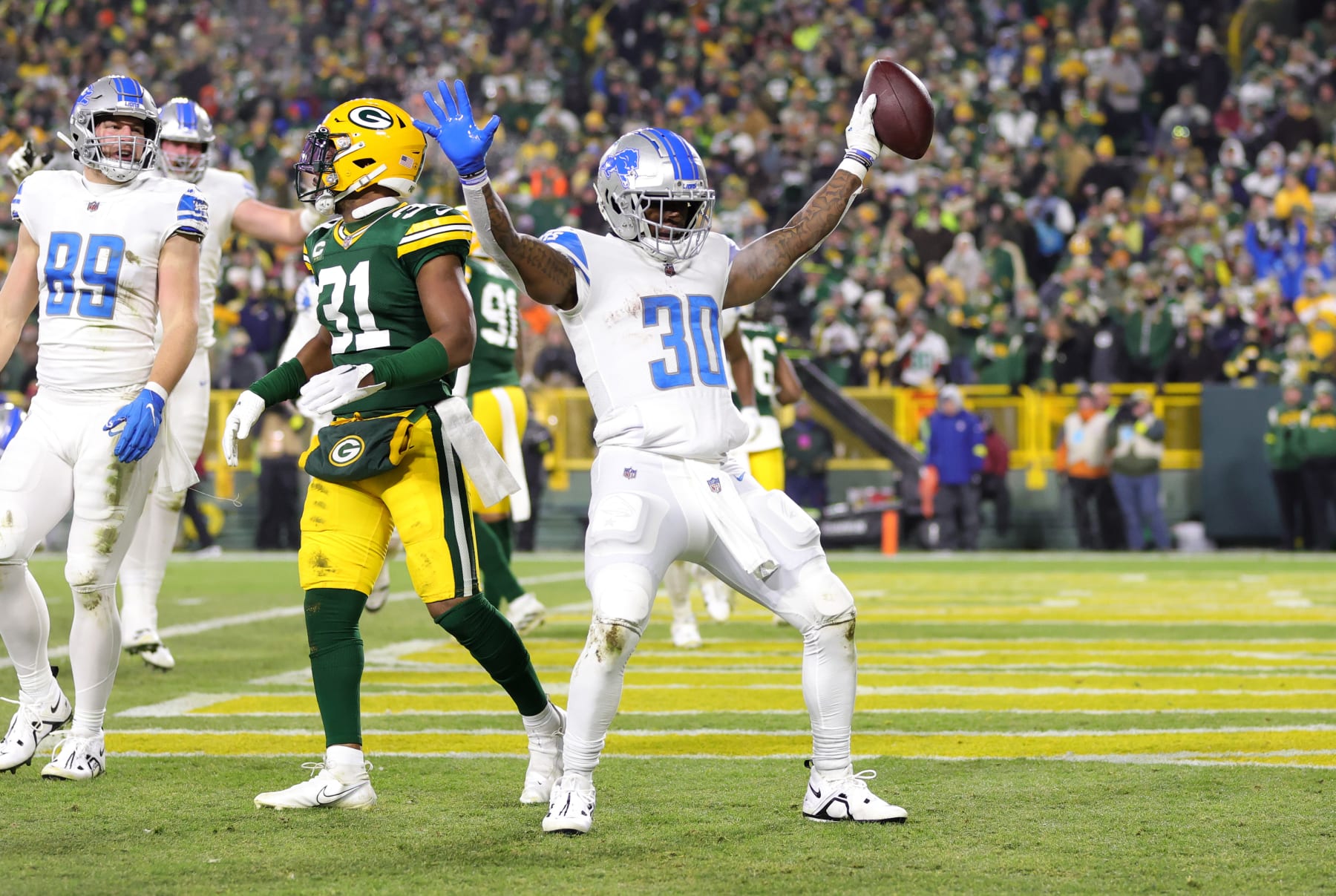 GREEN BAY, WISCONSIN - JANUARY 08: Jamaal Williams #30 of the Detroit Lions celebrates with teammates after a touchdown during the third quarter against the Green Bay Packers at Lambeau Field on January 08, 2023 in Green Bay, Wisconsin. (Photo by Stacy Revere/Getty Images)