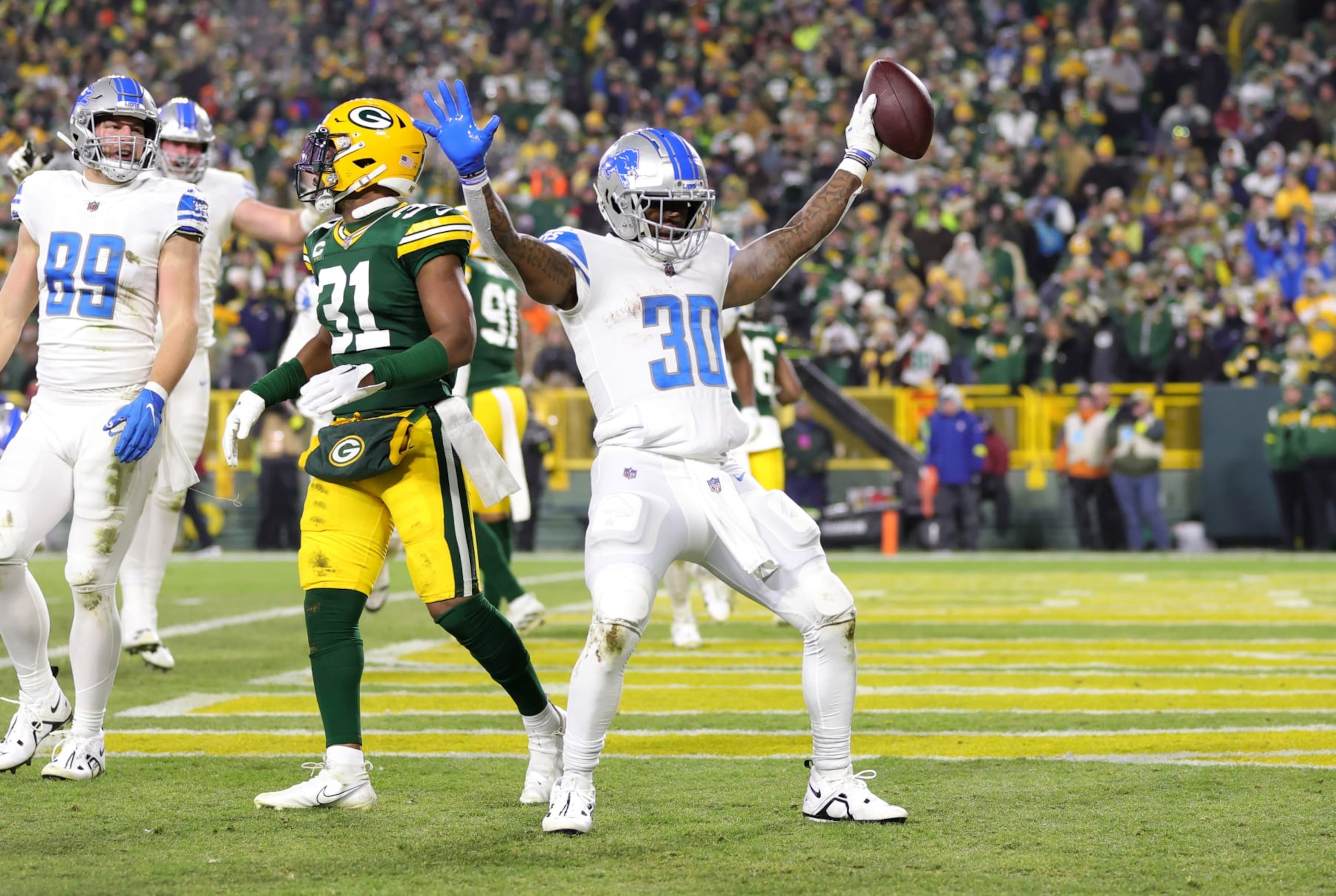 GREEN BAY, WISCONSIN - JANUARY 08: Jamaal Williams #30 of the Detroit Lions celebrates with teammates after a touchdown during the third quarter against the Green Bay Packers at Lambeau Field on January 08, 2023 in Green Bay, Wisconsin. (Photo by Stacy Revere/Getty Images) GREEN BAY, WISCONSIN - JANUARY 08: Jamaal Williams #30 of the Detroit Lions celebrates with teammates after a touchdown during the third quarter against the Green Bay Packers at Lambeau Field on January 08, 2023 in Green Bay, Wisconsin. (Photo by Stacy Revere/Getty Images)
