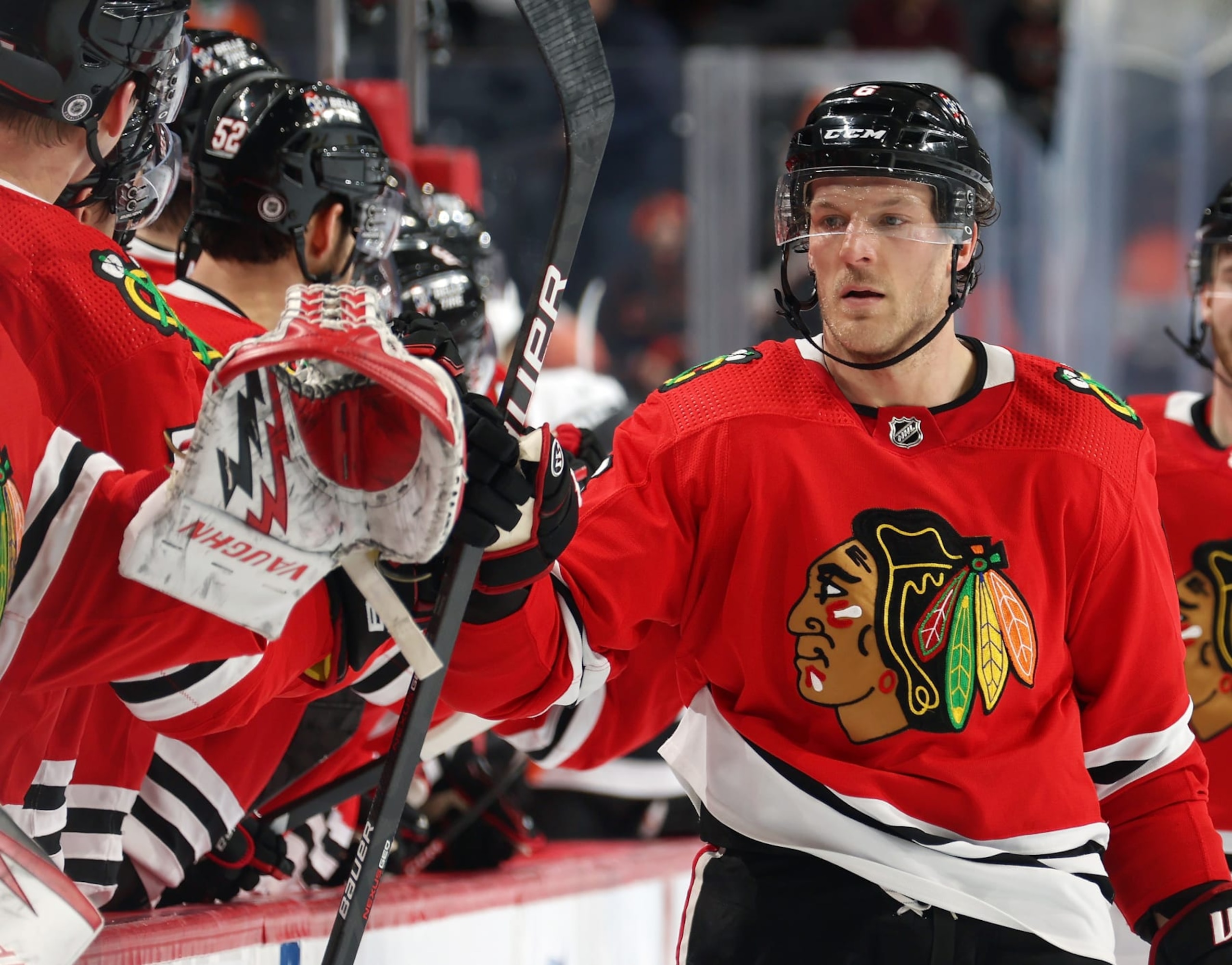PHILADELPHIA, PENNSYLVANIA - JANUARY 19:  Jake McCabe #6 of the Chicago Blackhawks celebrates a third period goal with teammates on the bench against the Philadelphia Flyers at the Wells Fargo Center on January 19, 2023 in Philadelphia, Pennsylvania.  (Photo by Len Redkoles/NHLI via Getty Images)