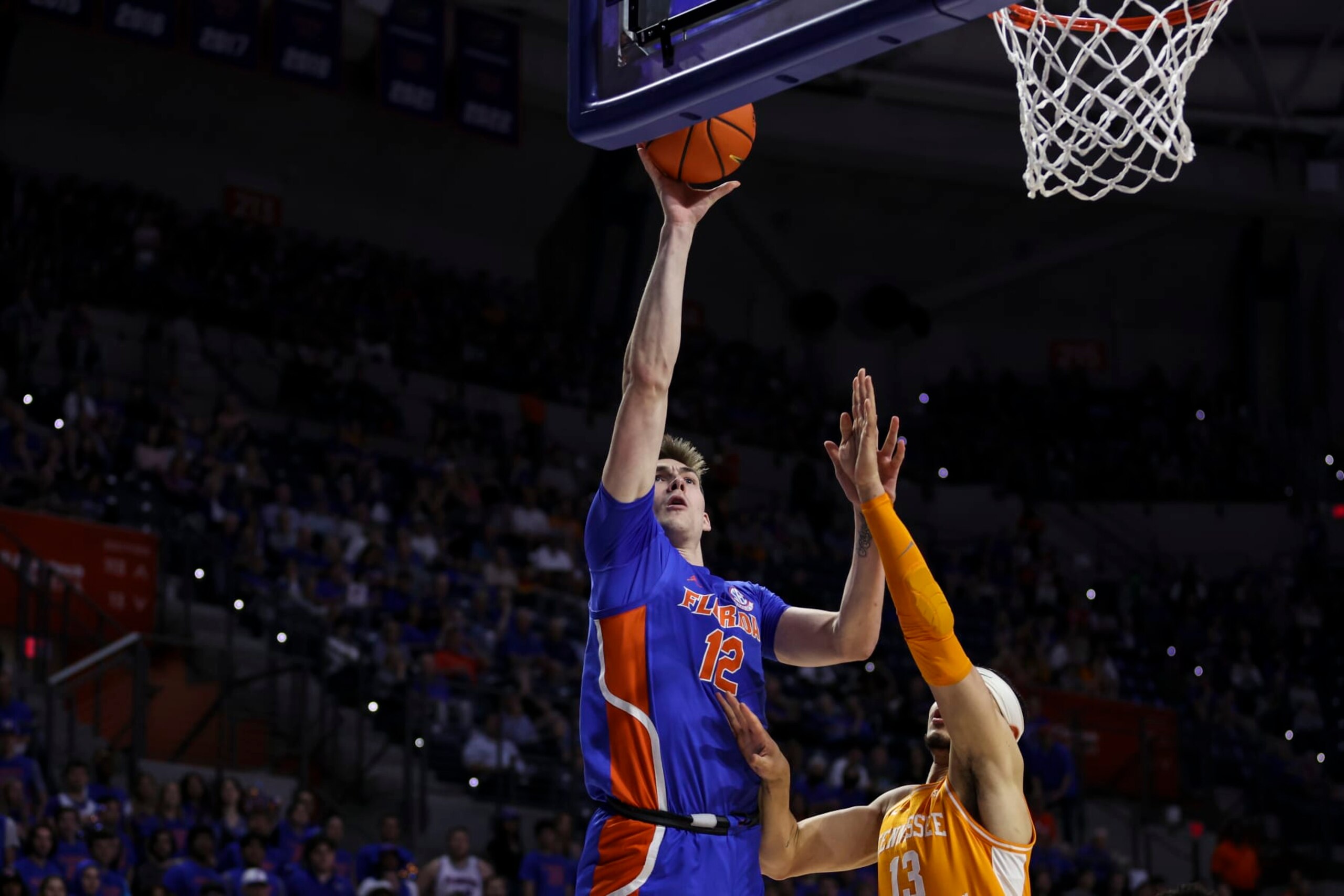 GAINESVILLE, FLORIDA - FEBRUARY 01: Colin Castleton #12 of the Florida Gators shoots the ball against Olivier Nkamhoua #13 of the Tennessee Volunteers during the first half of a game at the Stephen C. O'Connell Center on February 01, 2023 in Gainesville, Florida. (Photo by James Gilbert/Getty Images)