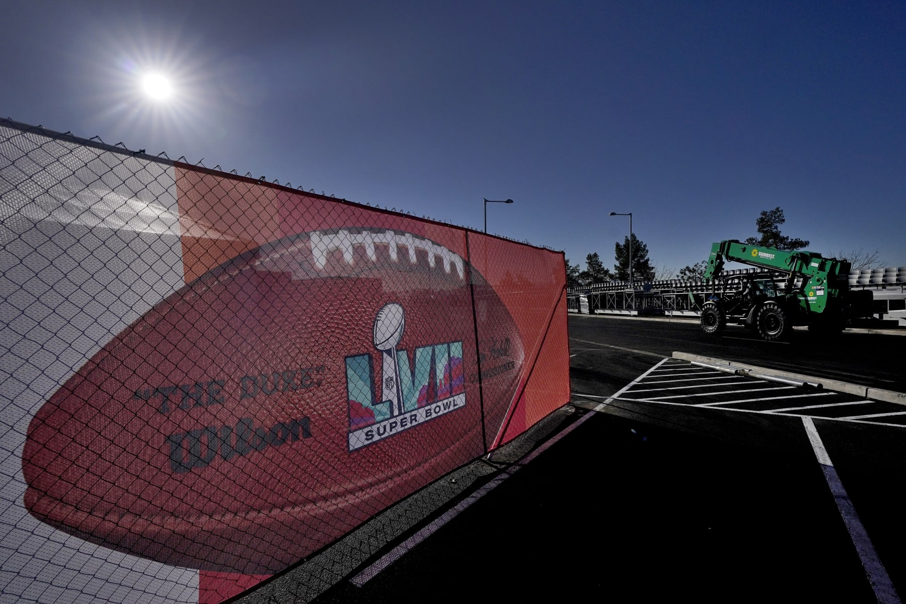 Workers prepare for the NFL Super Bowl LVII football game outside State Farm Stadium, Wednesday, Feb. 1, 2023, in Glendale, Ariz. (AP Photo/Matt York)