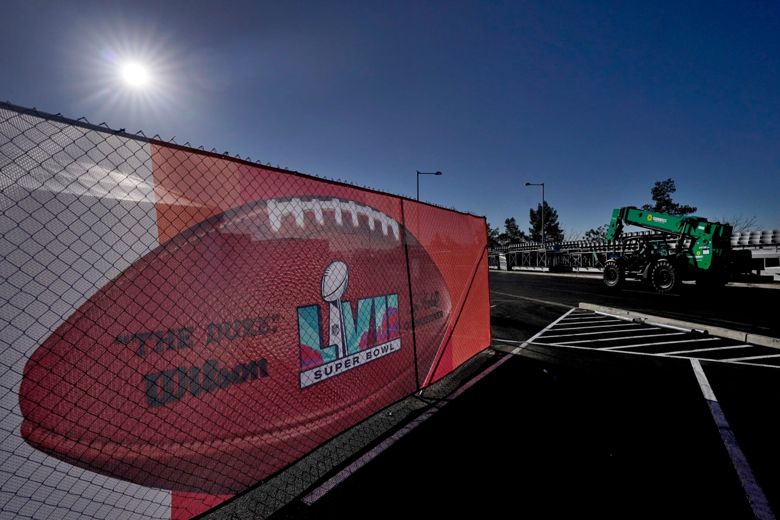 Workers prepare for the NFL Super Bowl LVII football game outside State Farm Stadium, Wednesday, Feb. 1, 2023, in Glendale, Ariz. (AP Photo/Matt York)