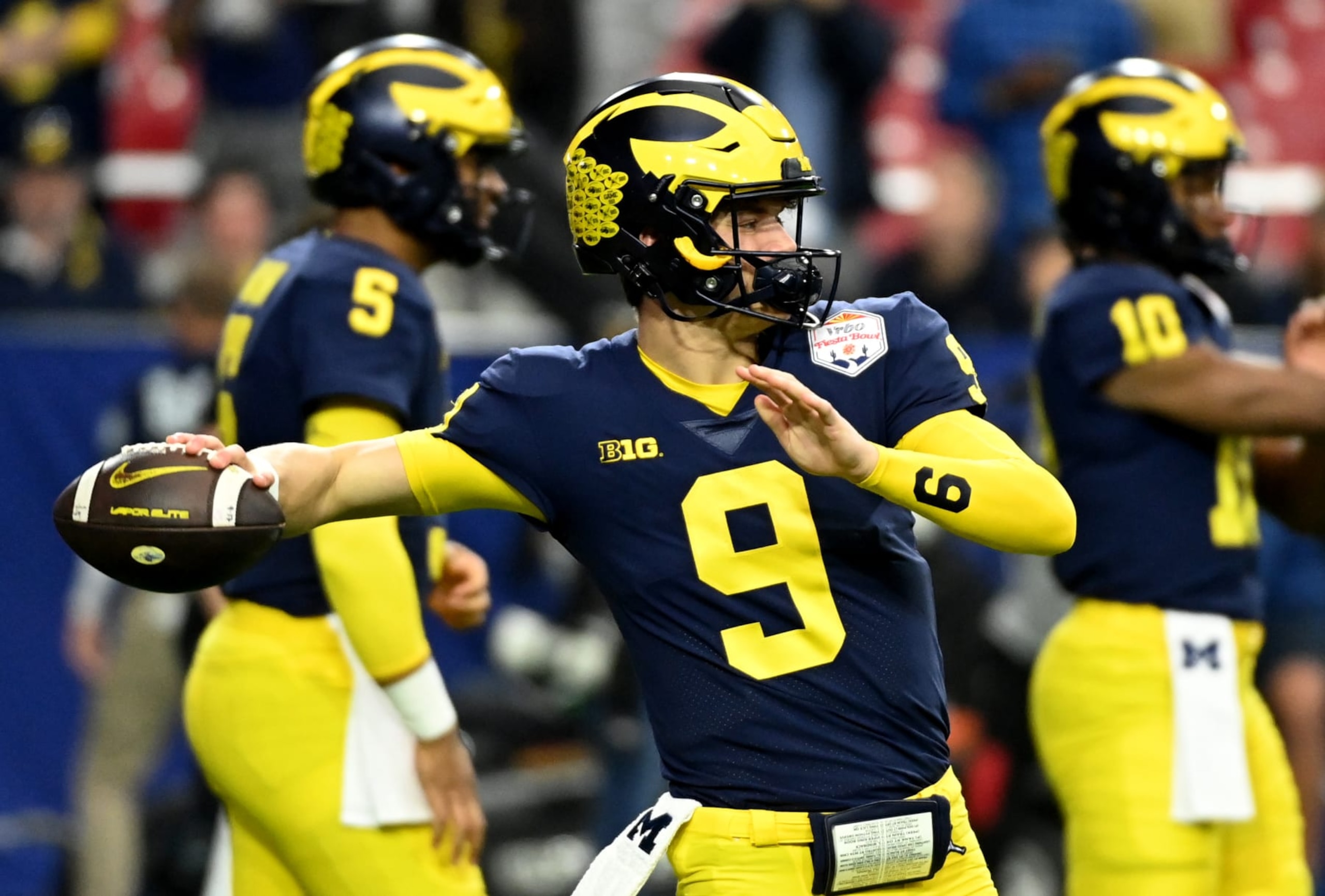 GLENDALE, ARIZONA - DECEMBER 31: JJ McCarthy #9 of the Michigan Wolverines prepares for a game against the TCU Horned Frogs during the Vrbo Fiesta Bowl at State Farm Stadium on December 31, 2022 in Glendale, Arizona. (Photo by Norm Hall/Getty Images)