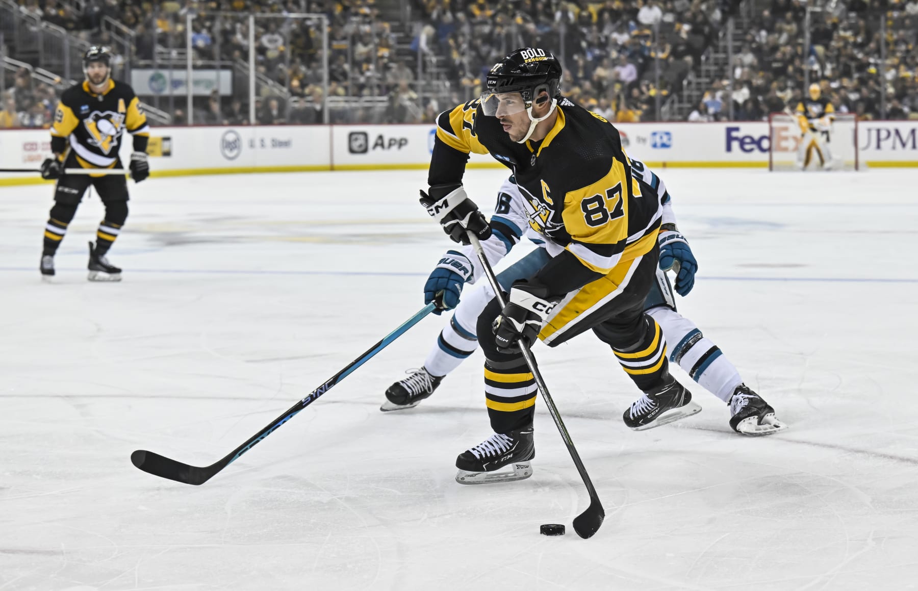 PITTSBURGH, PA - JANUARY 28: Pittsburgh Penguins Center Sidney Crosby (87) shoots the puck during the first period in the NHL game between the Pittsburgh Penguins and the San Jose Sharks on January 28, 2023, at PPG Paints Arena in Pittsburgh, PA. (Photo by Jeanine Leech/Icon Sportswire via Getty Images)