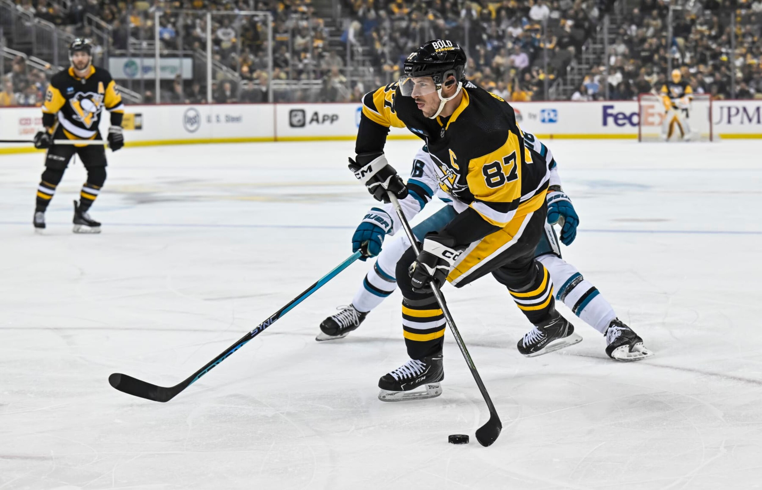 PITTSBURGH, PA - JANUARY 28: Pittsburgh Penguins Center Sidney Crosby (87) shoots the puck during the first period in the NHL game between the Pittsburgh Penguins and the San Jose Sharks on January 28, 2023, at PPG Paints Arena in Pittsburgh, PA. (Photo by Jeanine Leech/Icon Sportswire via Getty Images)