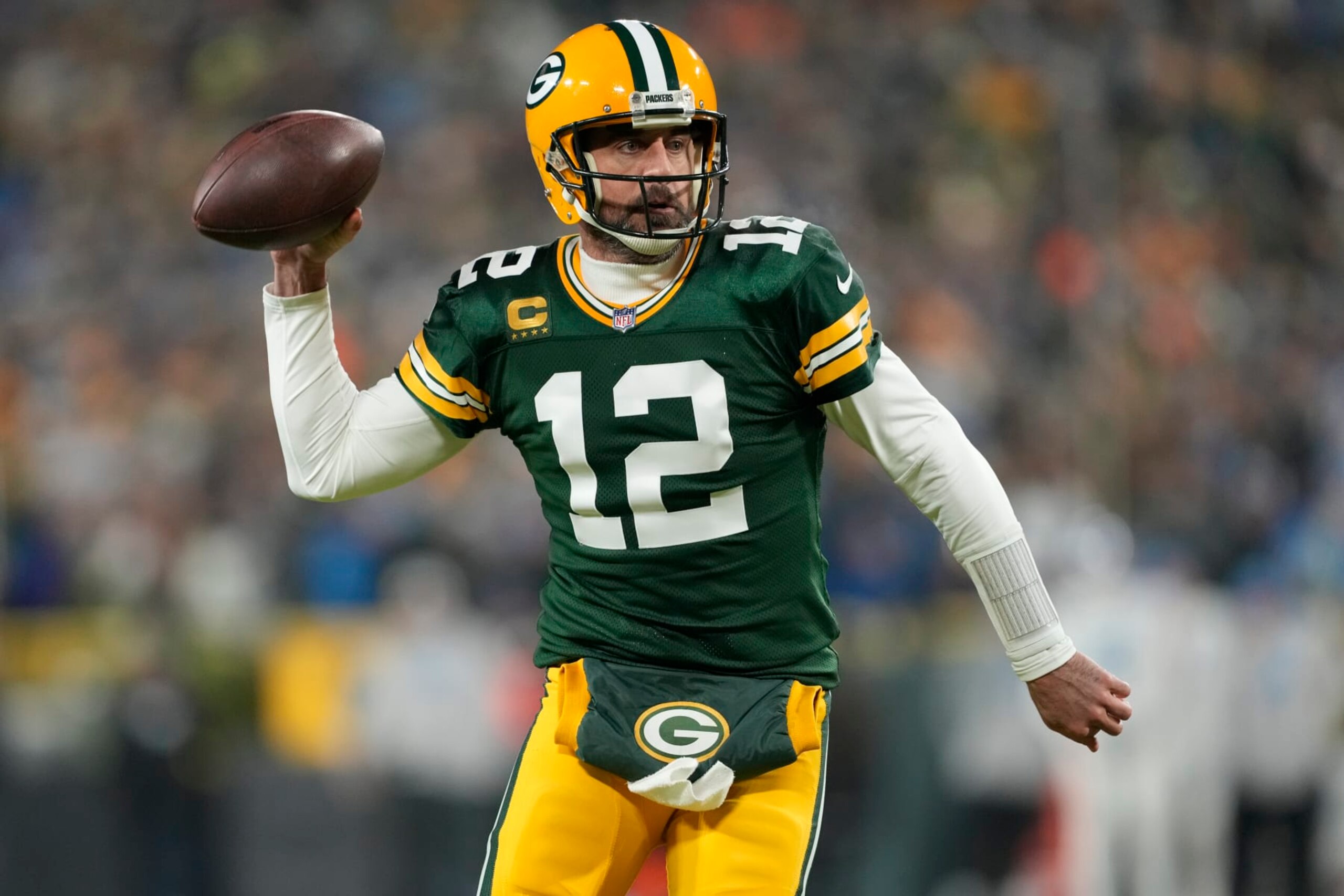 GREEN BAY, WISCONSIN - JANUARY 08: Aaron Rodgers #12 of the Green Bay Packers looks to pass during the first quarter against the Detroit Lions at Lambeau Field on January 08, 2023 in Green Bay, Wisconsin. (Photo by Patrick McDermott/Getty Images)