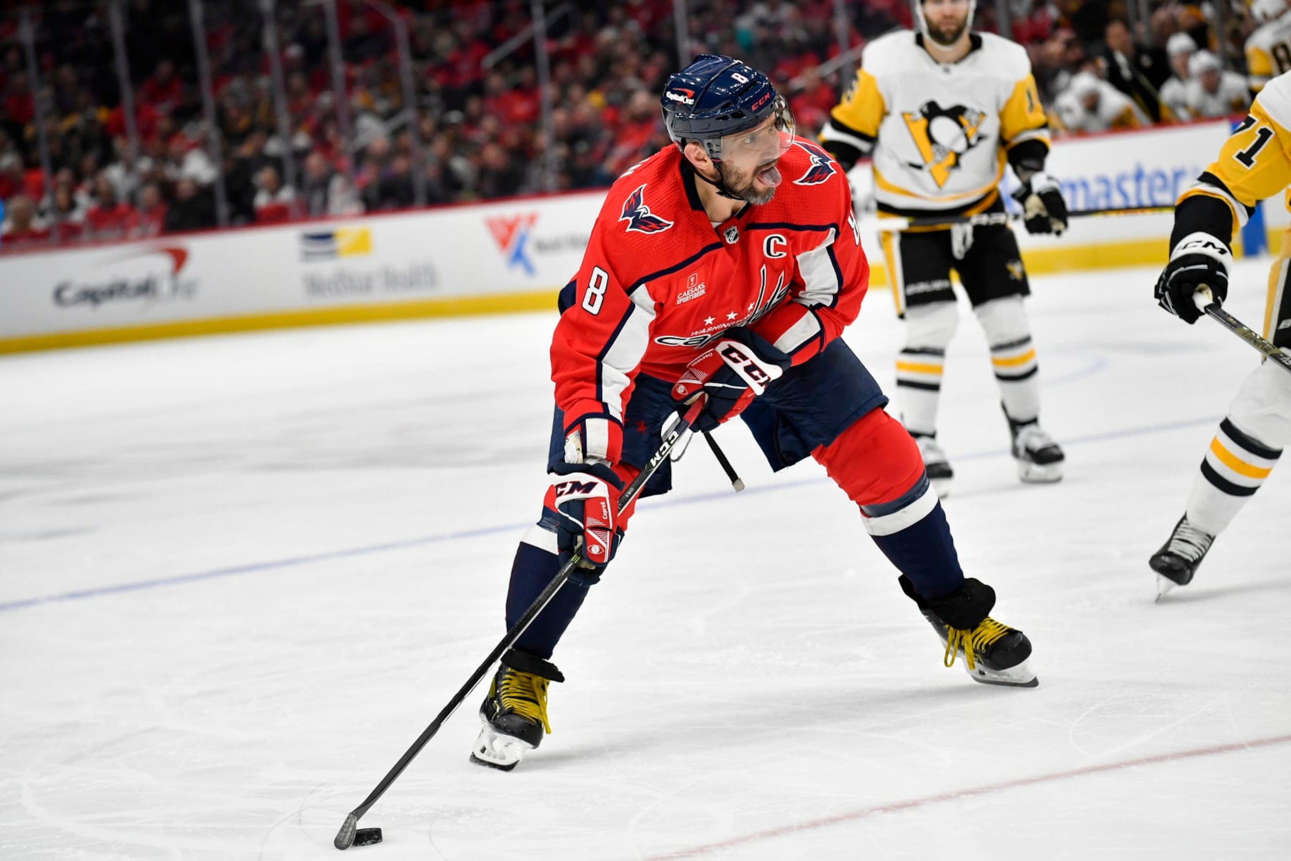 WASHINGTON, DC - JANUARY 26: Capitals left wing Alexander Alex Ovechkin (8) makes a pass with his toungue out during the Pittsburgh Penguins versus Washington Capitals National Hockey League game on January 26, 2023 at Capital One Arena in Washington, D.C.. (Photo by Randy Litzinger/Icon Sportswire via Getty Images)