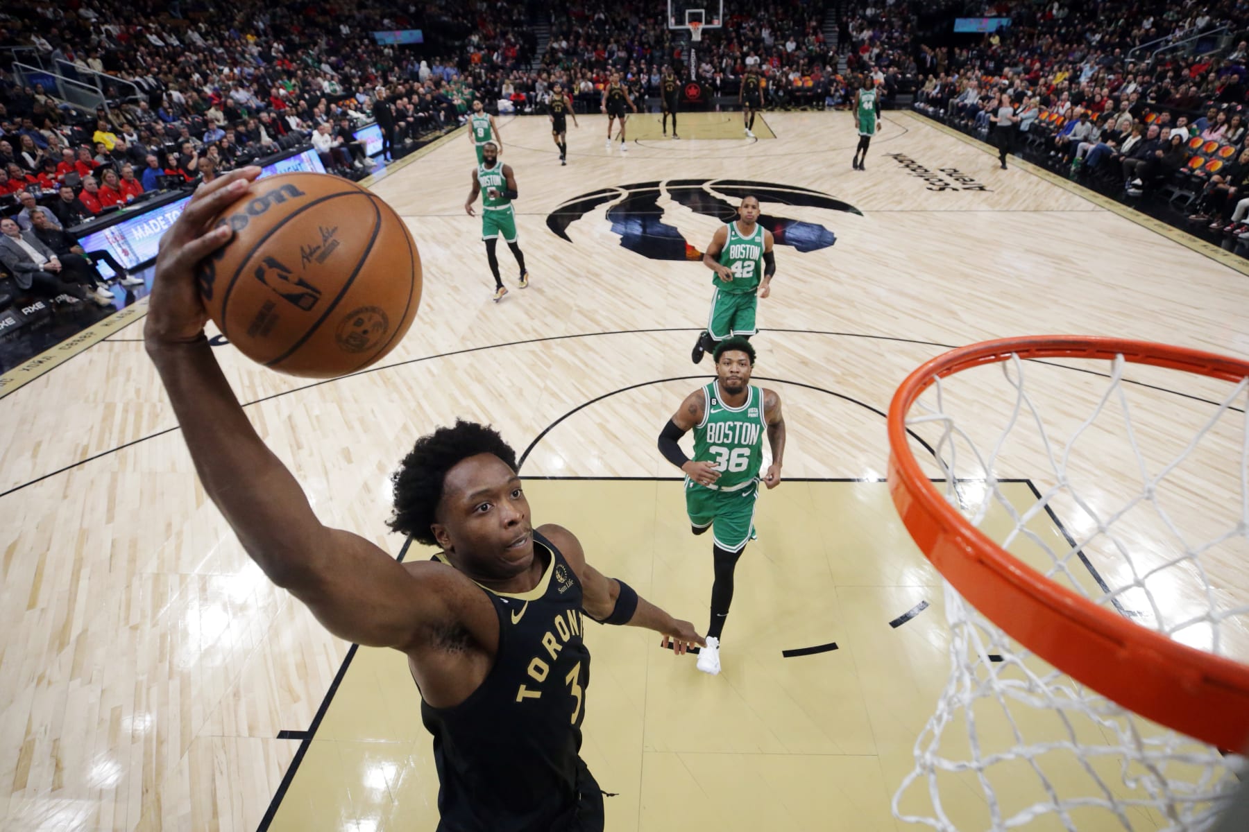 TORONTO, ON - JANUARY 21: O.G. Anunoby #3 of the Toronto Raptors drives to the net as Marcus Smart #36 of the Boston Celtics trails on defense during the first half of their NBA game at Scotiabank Arena on January 21, 2023 in Toronto, Canada. NOTE TO USER: User expressly acknowledges and agrees that, by downloading and or using this photograph, User is consenting to the terms and conditions of the Getty Images License Agreement. (Photo by Cole Burston/Getty Images)