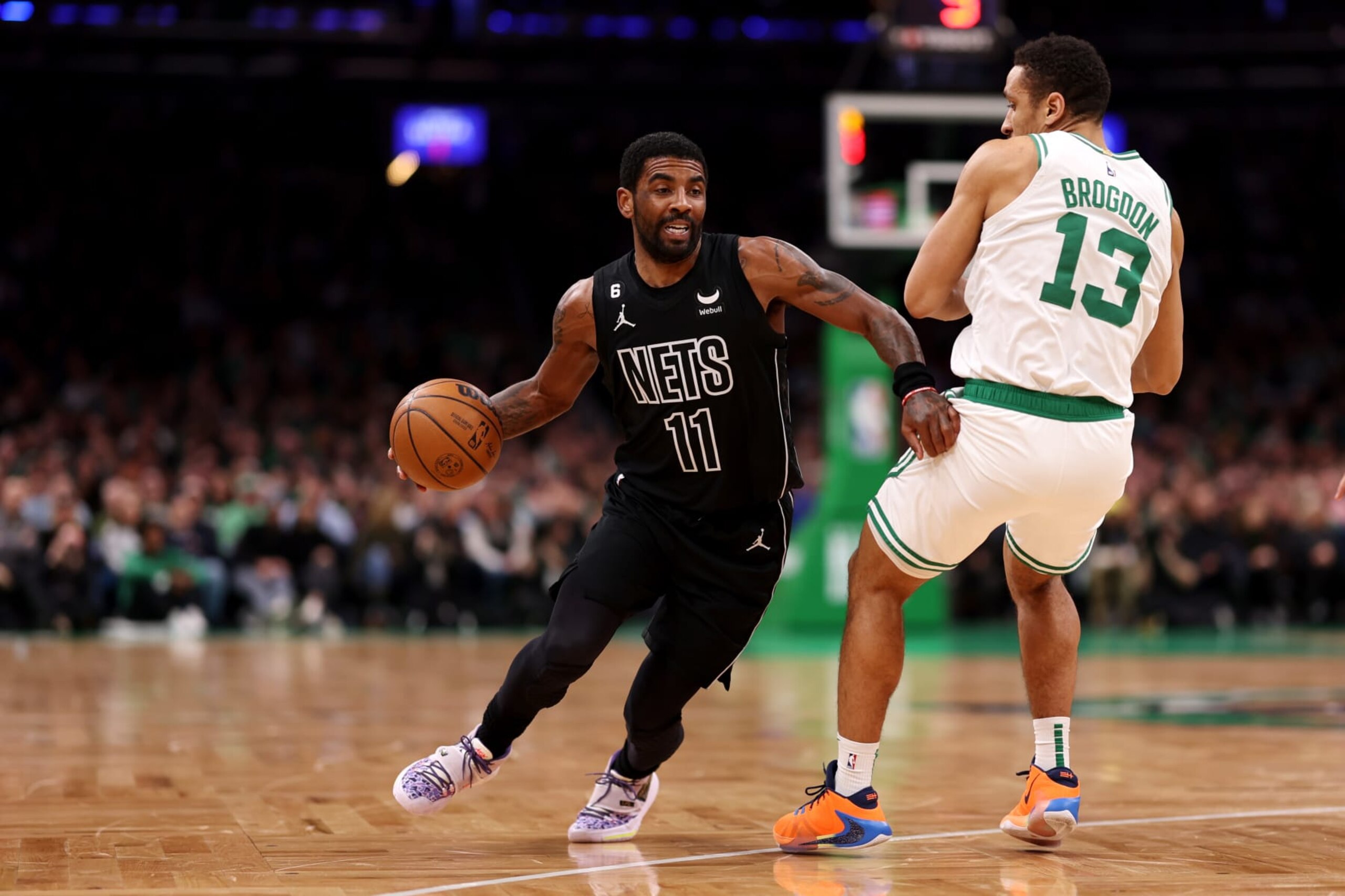 BOSTON, MASSACHUSETTS - FEBRUARY 01: Kyrie Irving #11 of the Brooklyn Nets dribbles past Malcolm Brogdon #13 of the Boston Celtics during the first half at TD Garden on February 01, 2023 in Boston, Massachusetts. (Photo by Maddie Meyer/Getty Images)