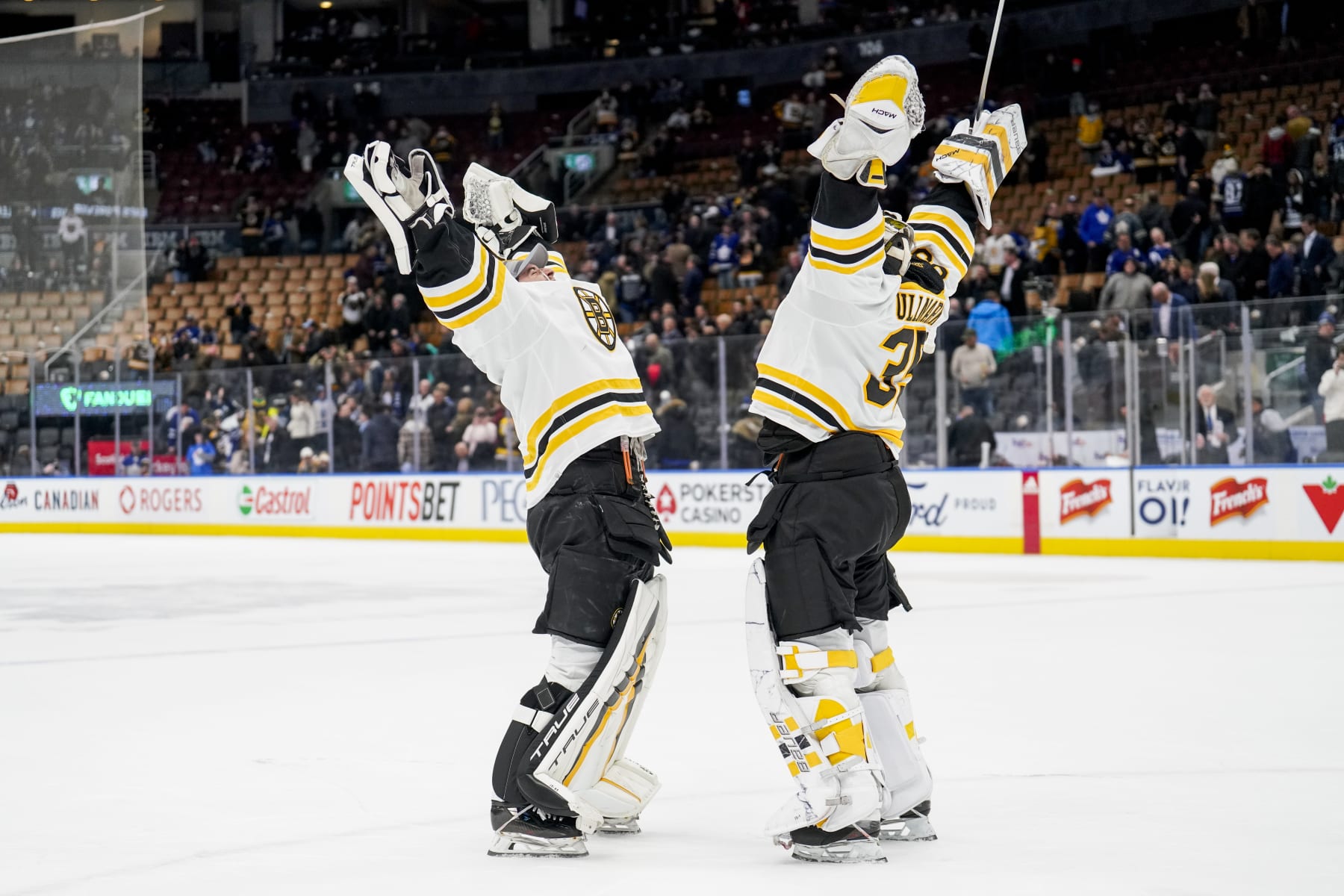 TORONTO, ON - FEBRUARY 1: Linus Ullmark #35 of the Boston Bruins celebrates with teammate Jeremy Swayman #1 after defeating the Toronto Maple Leafs at the Scotiabank Arena on February 1, 2023 in Toronto, Ontario, Canada. (Photo by Andrew Lahodynskyj/NHLI via Getty Images)