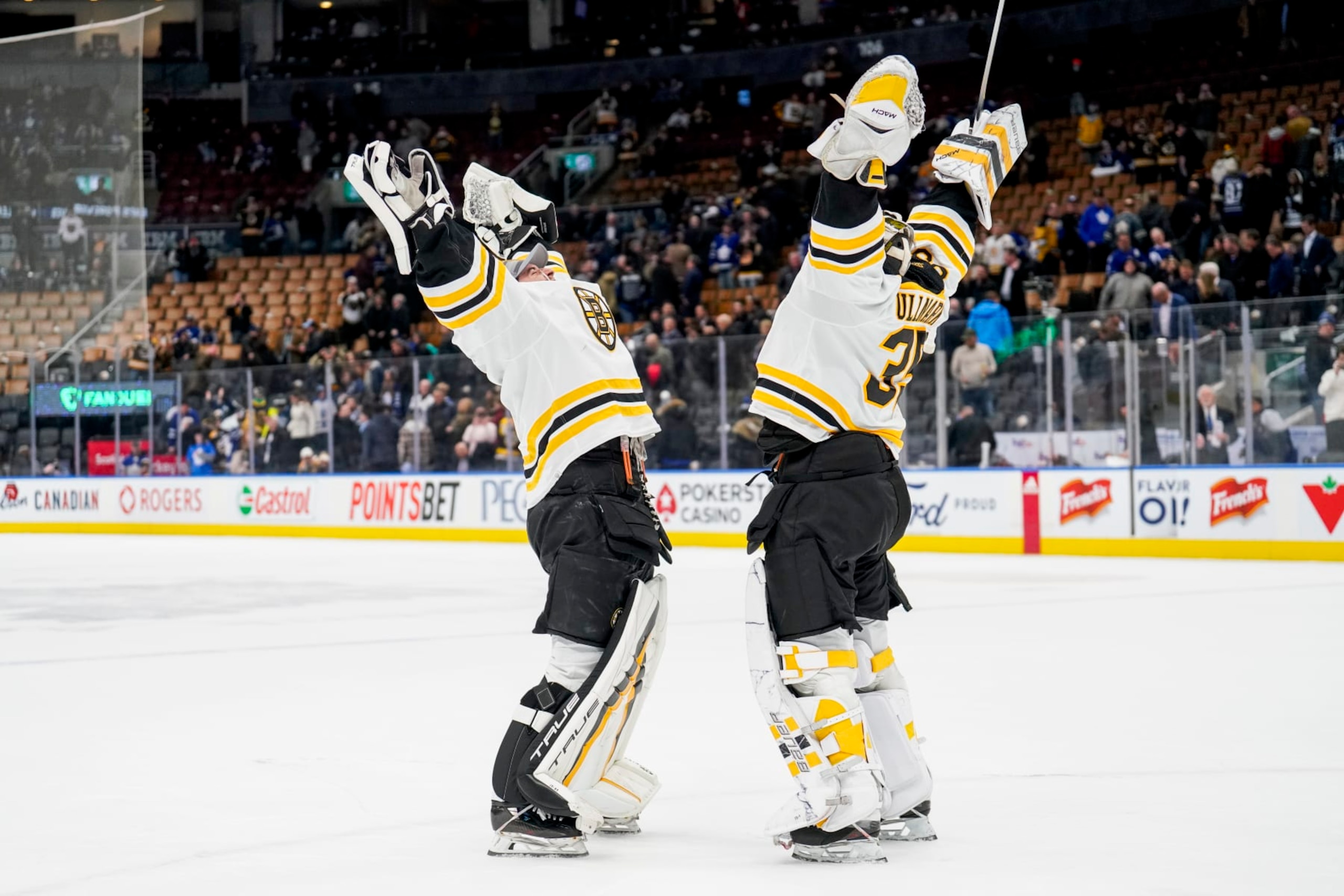 TORONTO, ON - FEBRUARY 1: Linus Ullmark #35 of the Boston Bruins celebrates with teammate Jeremy Swayman #1 after defeating the Toronto Maple Leafs at the Scotiabank Arena on February 1, 2023 in Toronto, Ontario, Canada. (Photo by Andrew Lahodynskyj/NHLI via Getty Images)