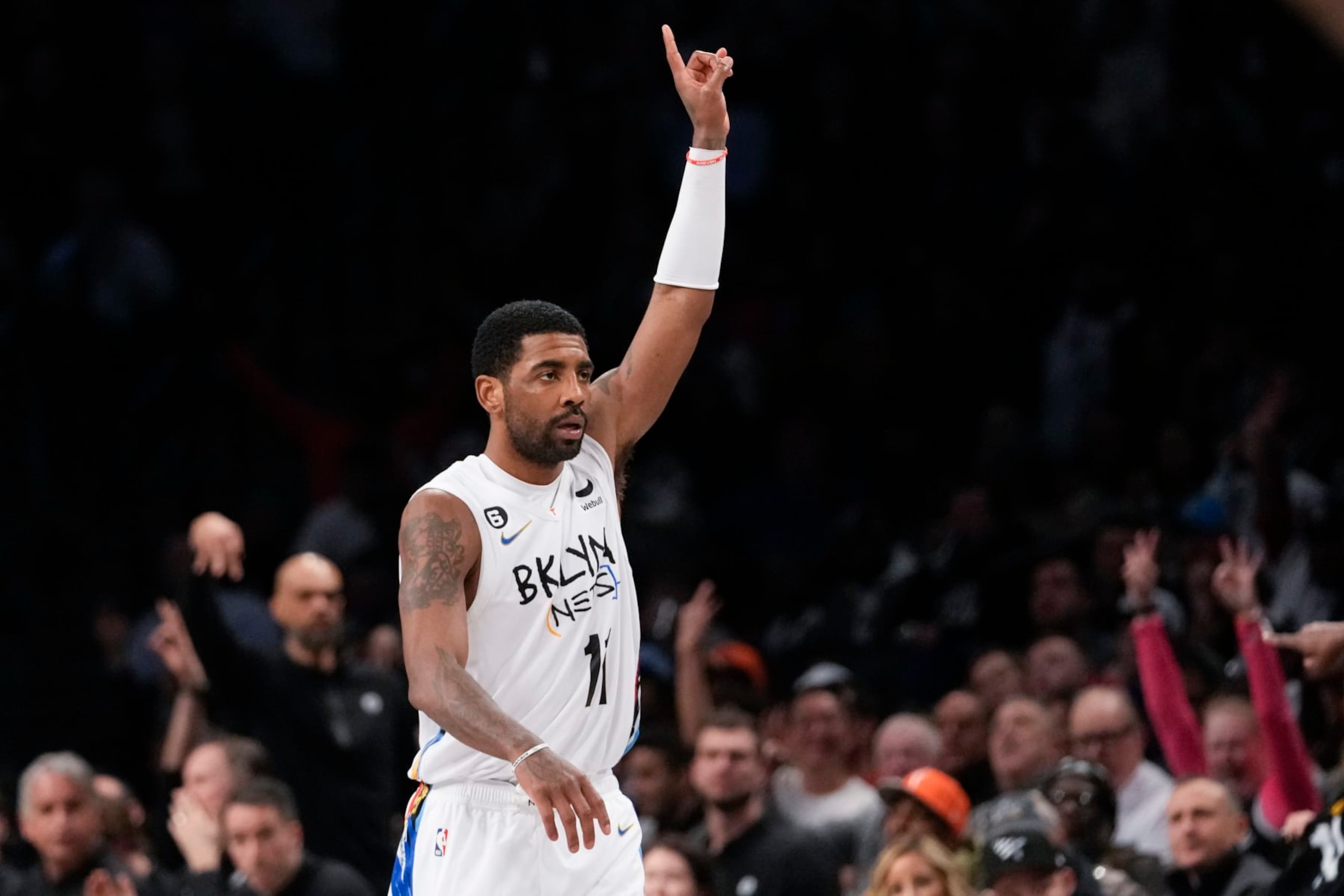 Brooklyn Nets guard Kyrie Irving reats after scoring a three-point basket during the second half of an NBA basketball game against the New York Knicks, Saturday, Jan. 28, 2023, in New York. The Nets won 122-115. (AP Photo/Mary Altaffer)