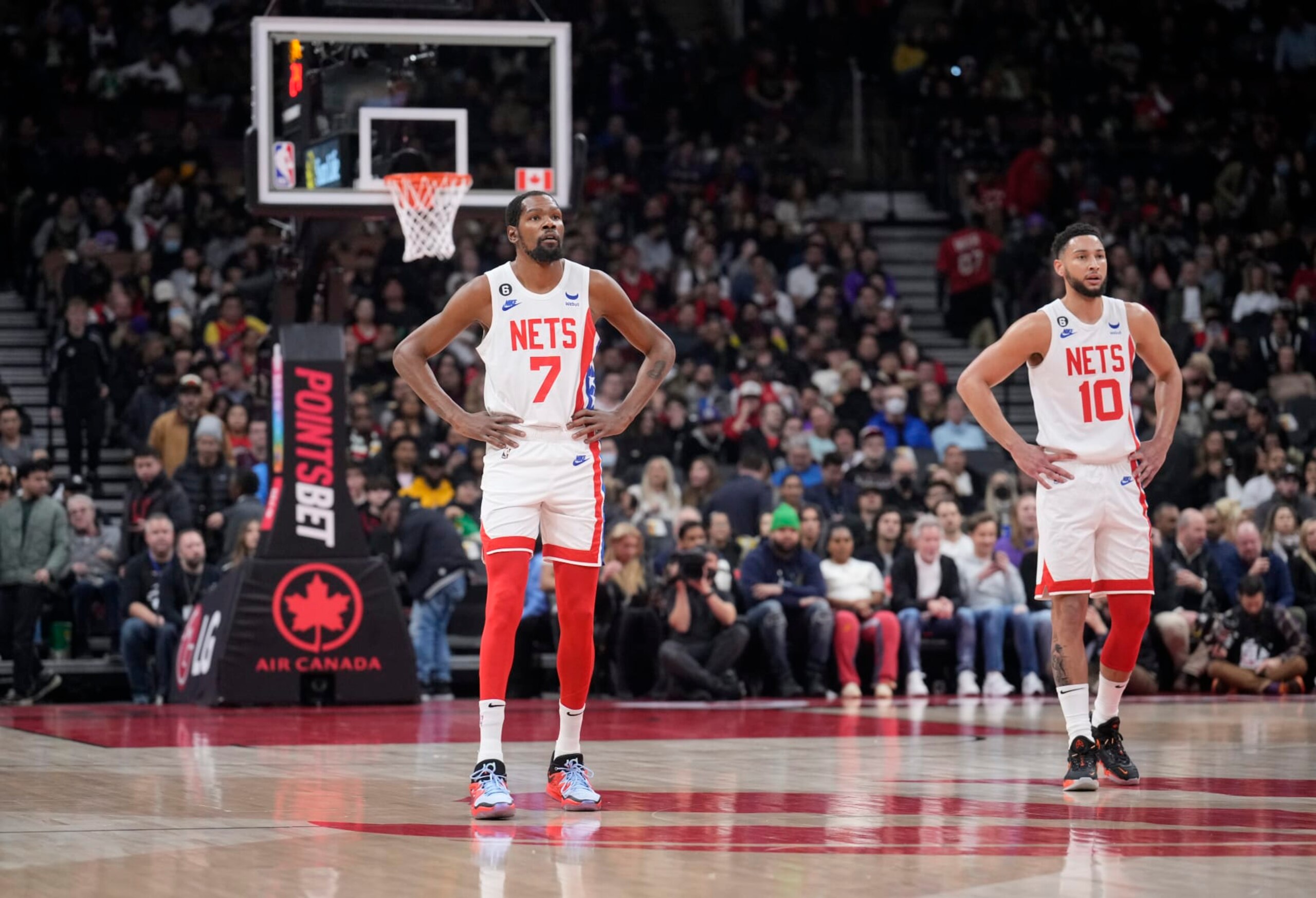 TORONTO, ON - DECEMBER 16: Kevin Durant #7 and Ben Simmons #10 of the Brooklyn Nets looks on against the Toronto Raptors during the first half of their basketball game at the Scotiabank Arena on December 16, 2022 in Toronto, Ontario, Canada. NOTE TO USER: User expressly acknowledges and agrees that, by downloading and/or using this Photograph, user is consenting to the terms and conditions of the Getty Images License Agreement. (Photo by Mark Blinch/Getty Images)